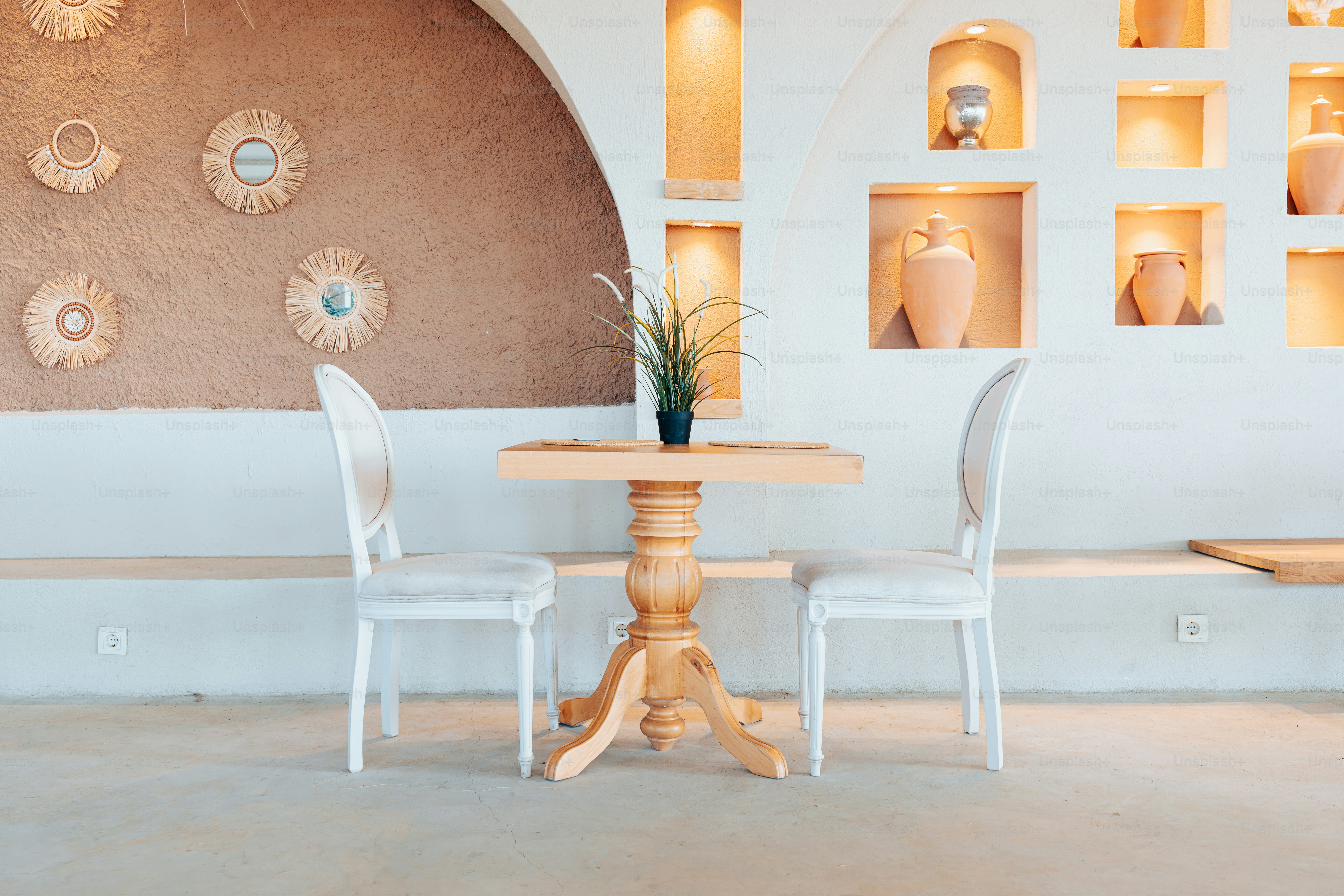 A dining room with a table and chairs