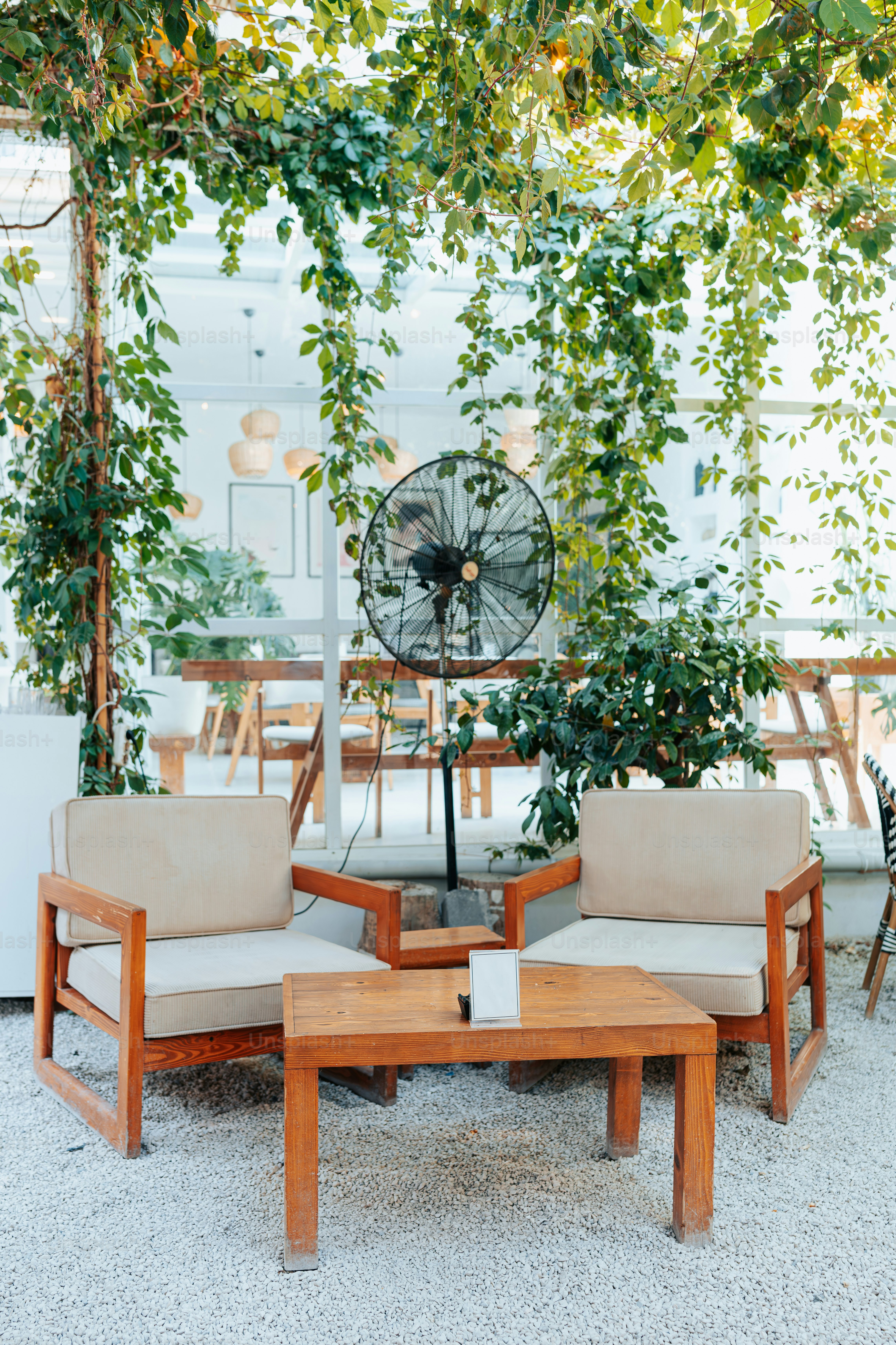 Covered patio using weatherproof cooling fans during warm summer evening