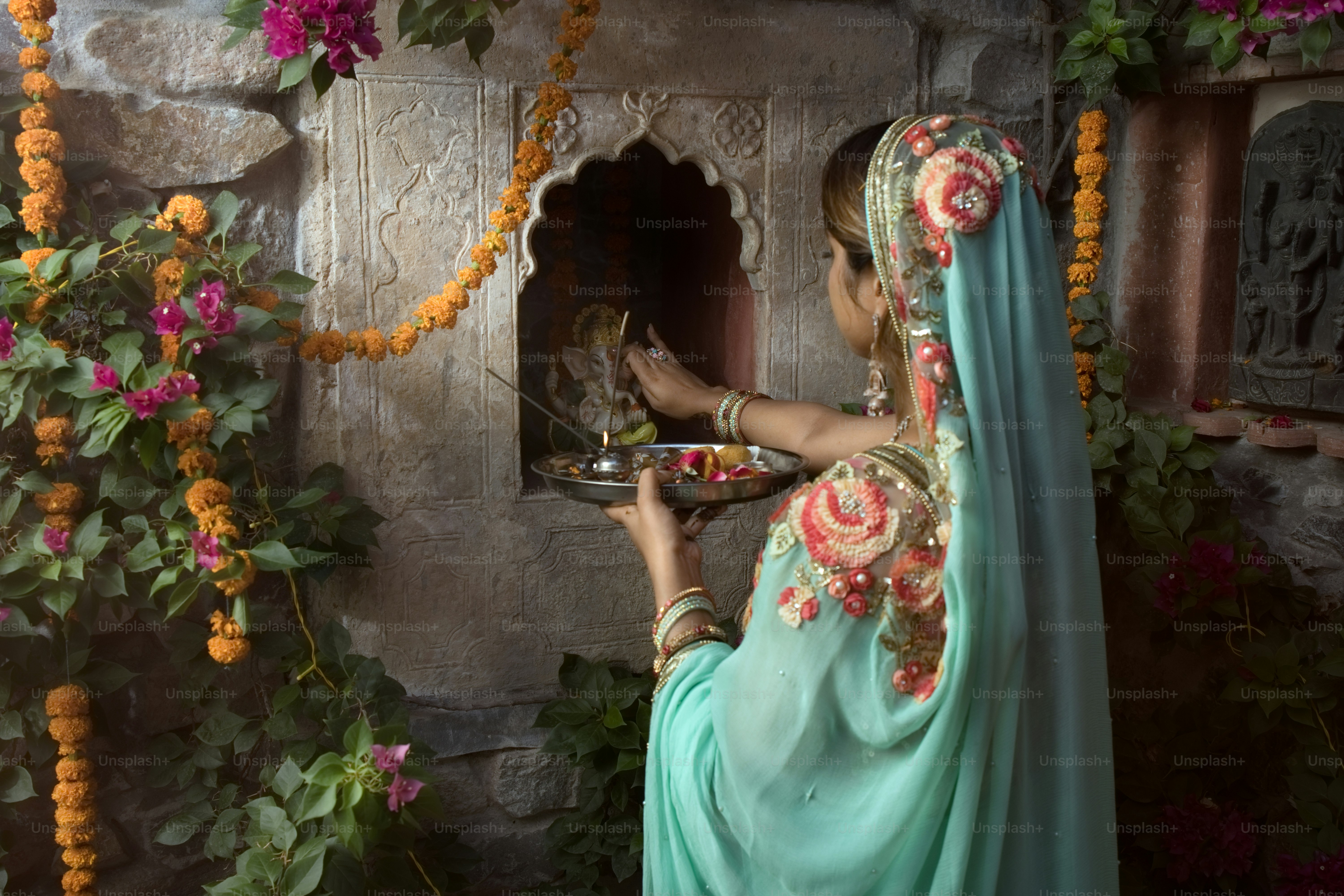 A woman in a blue dress holding a plate of food