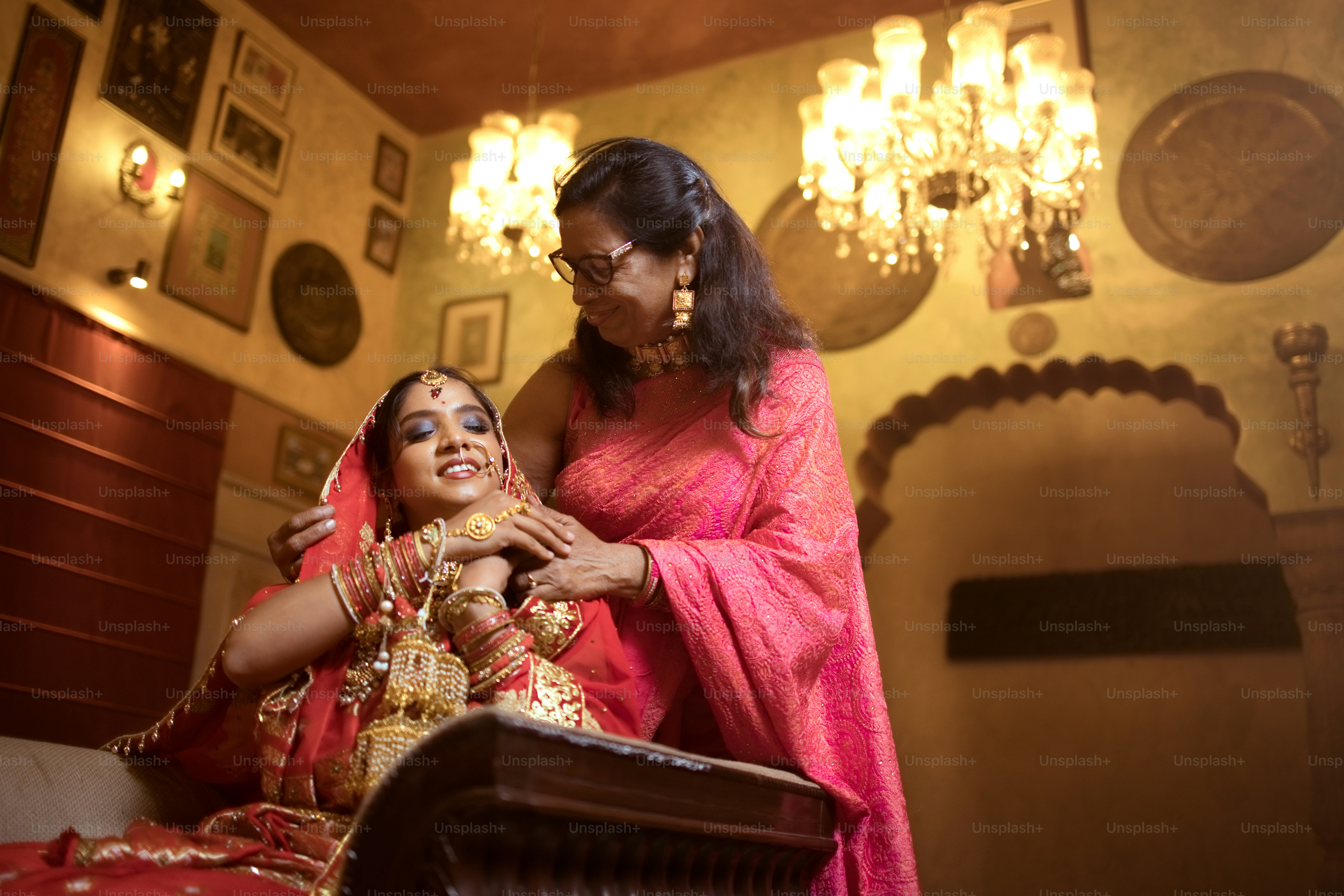 A woman standing next to a woman in a bed