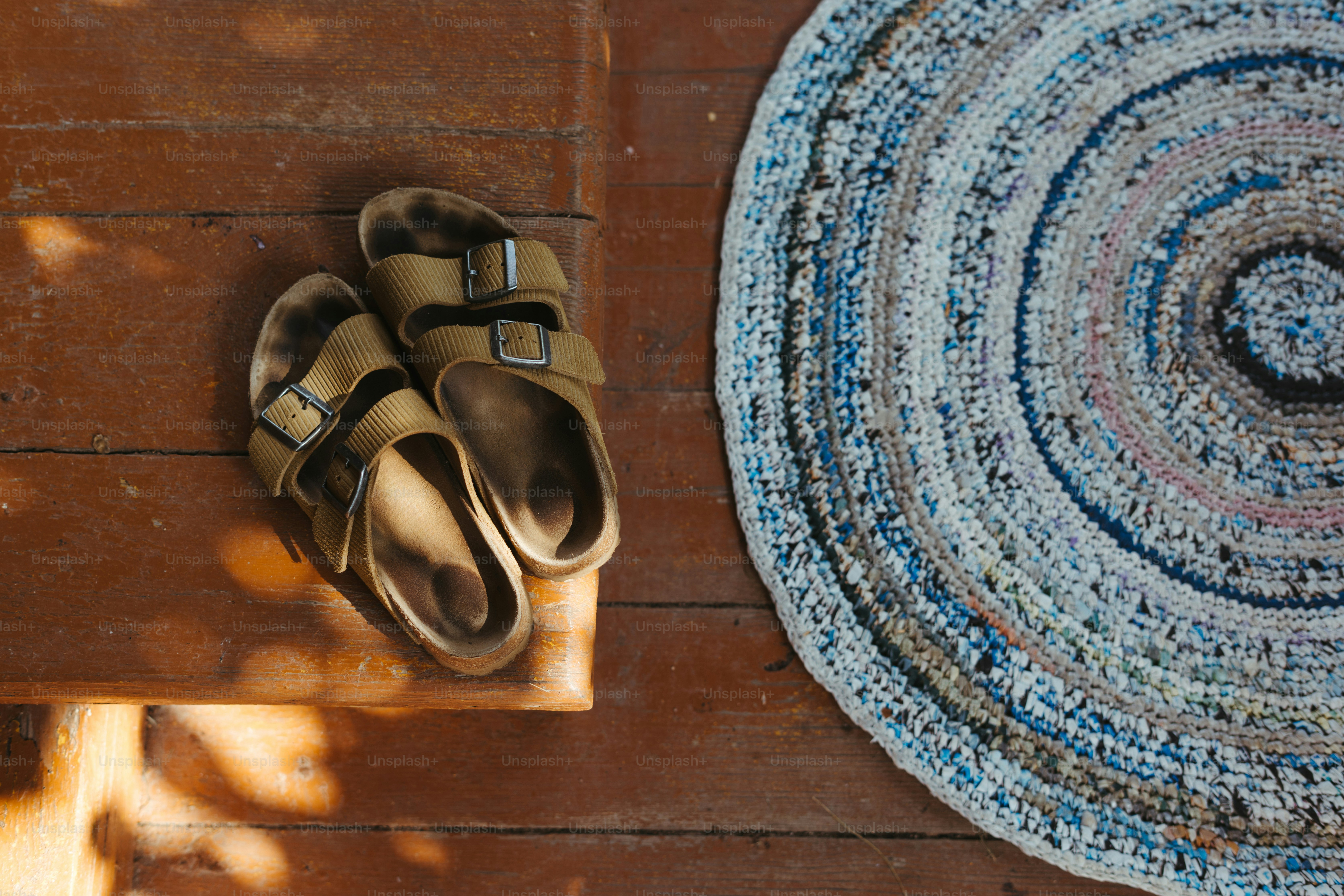 A pair of sandals sitting on top of a rug