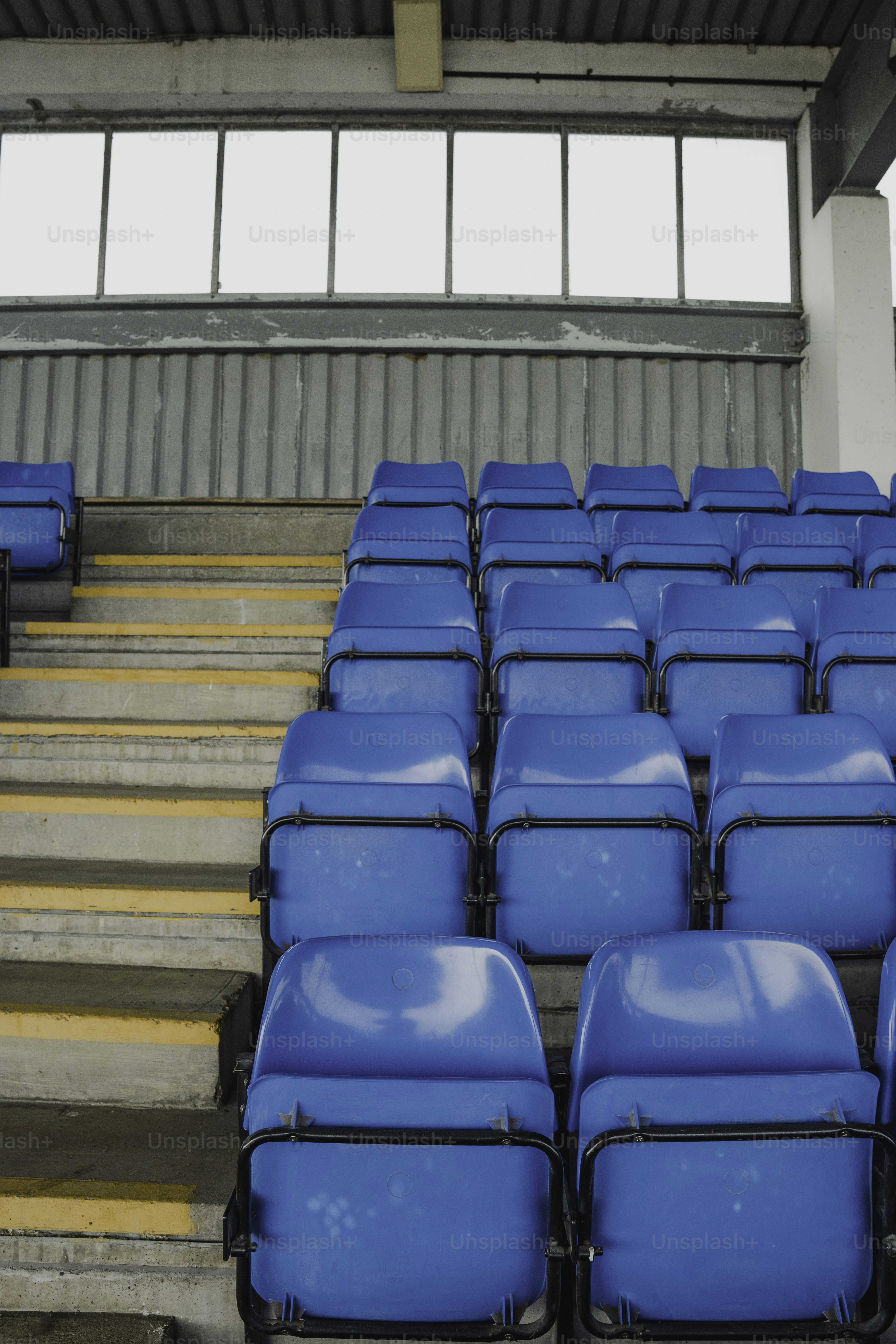 A row of blue seats in a stadium