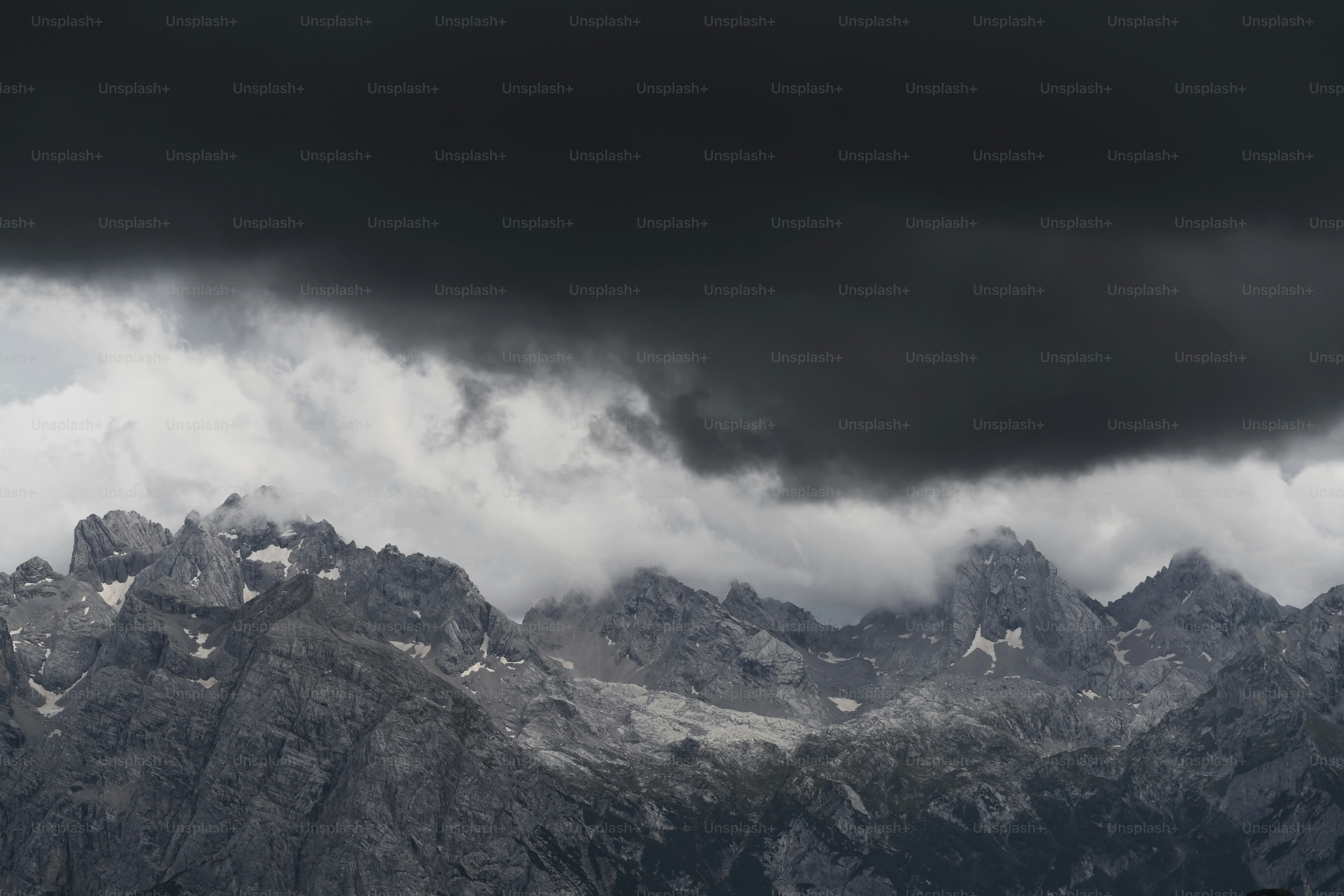 A mountain range with dark clouds in the sky