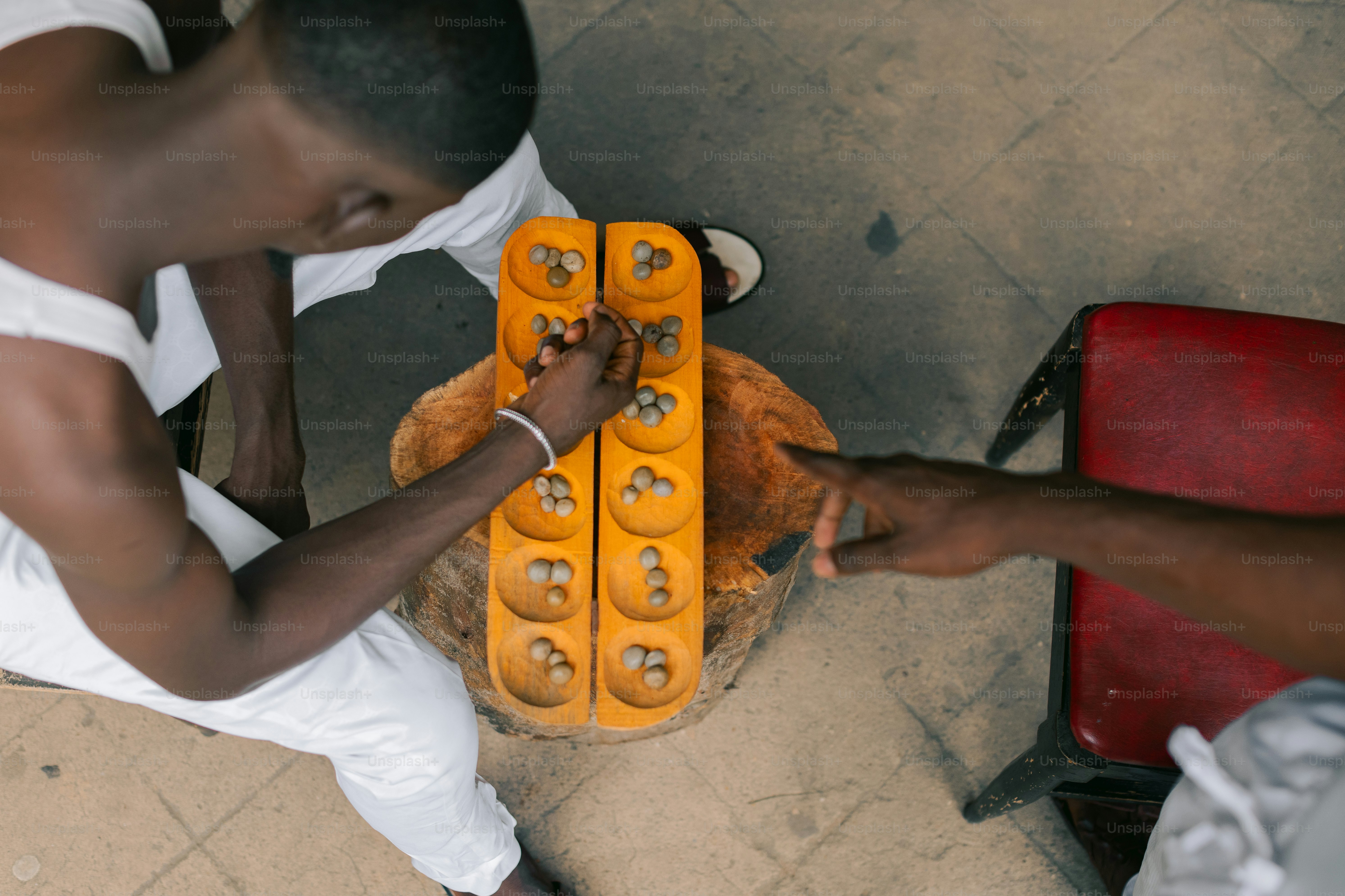 A man is holding a teddy bear made out of legos