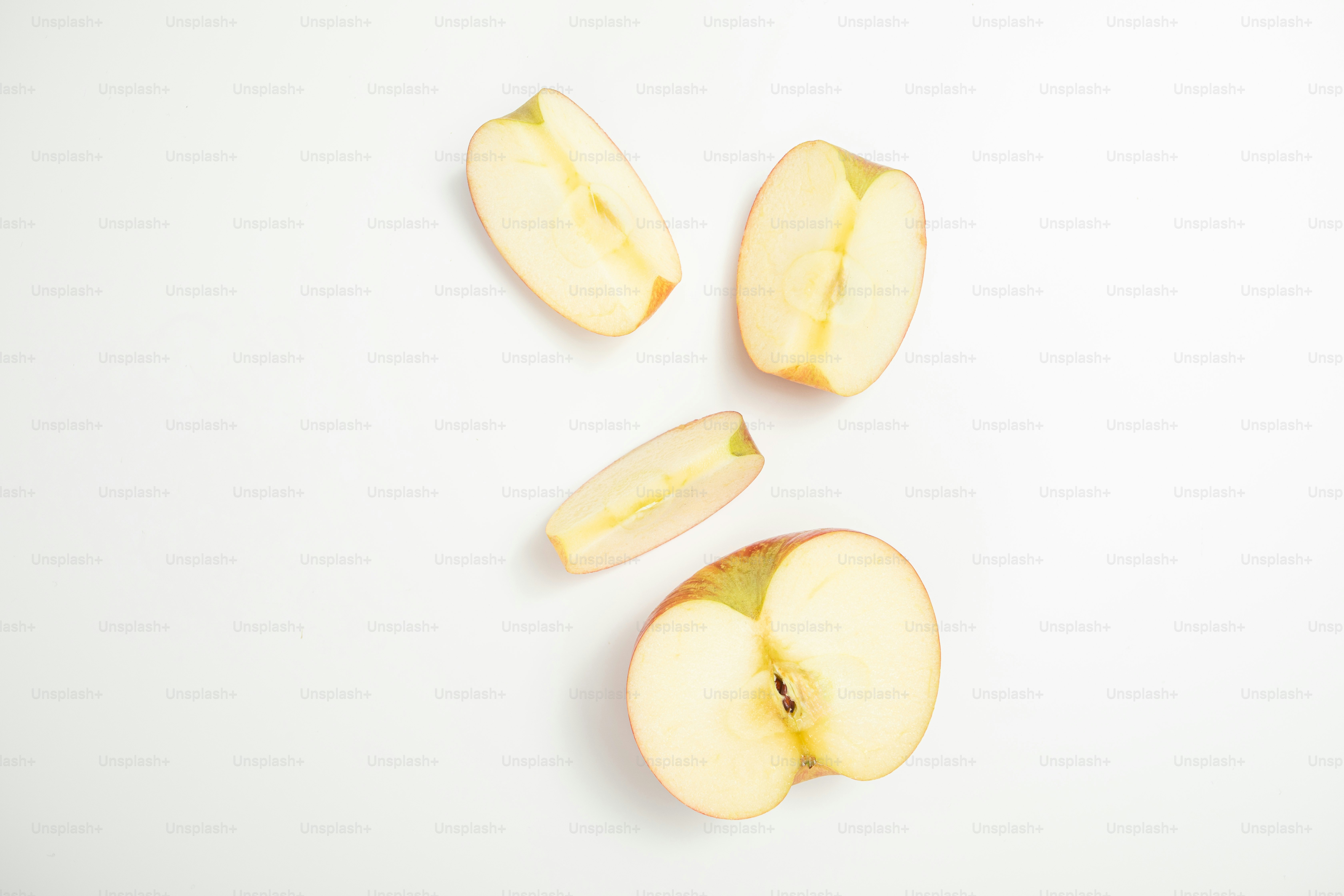 A sliced apple sitting on top of a white table