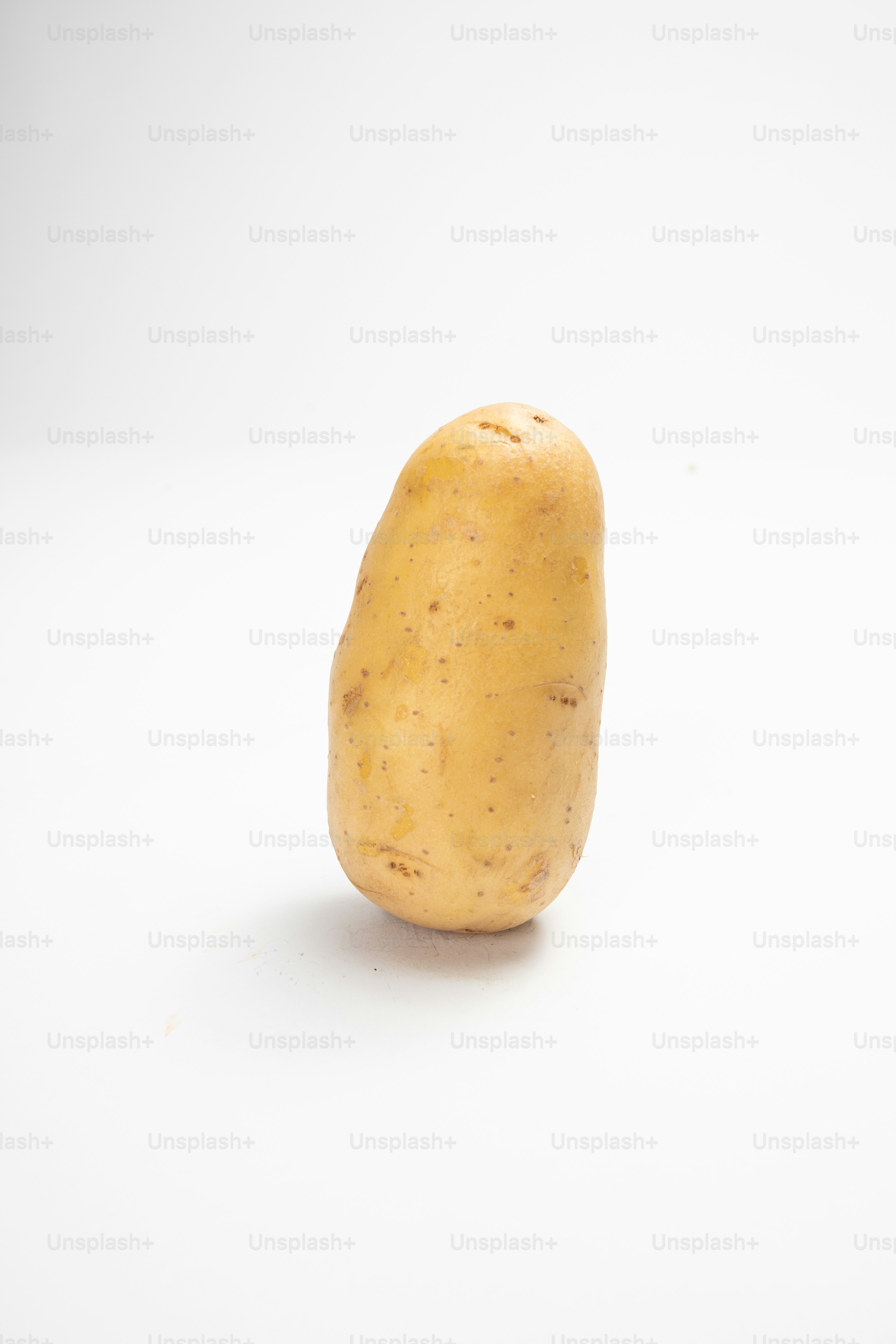 Eine einzelne Kartoffel auf weißem Hintergrund