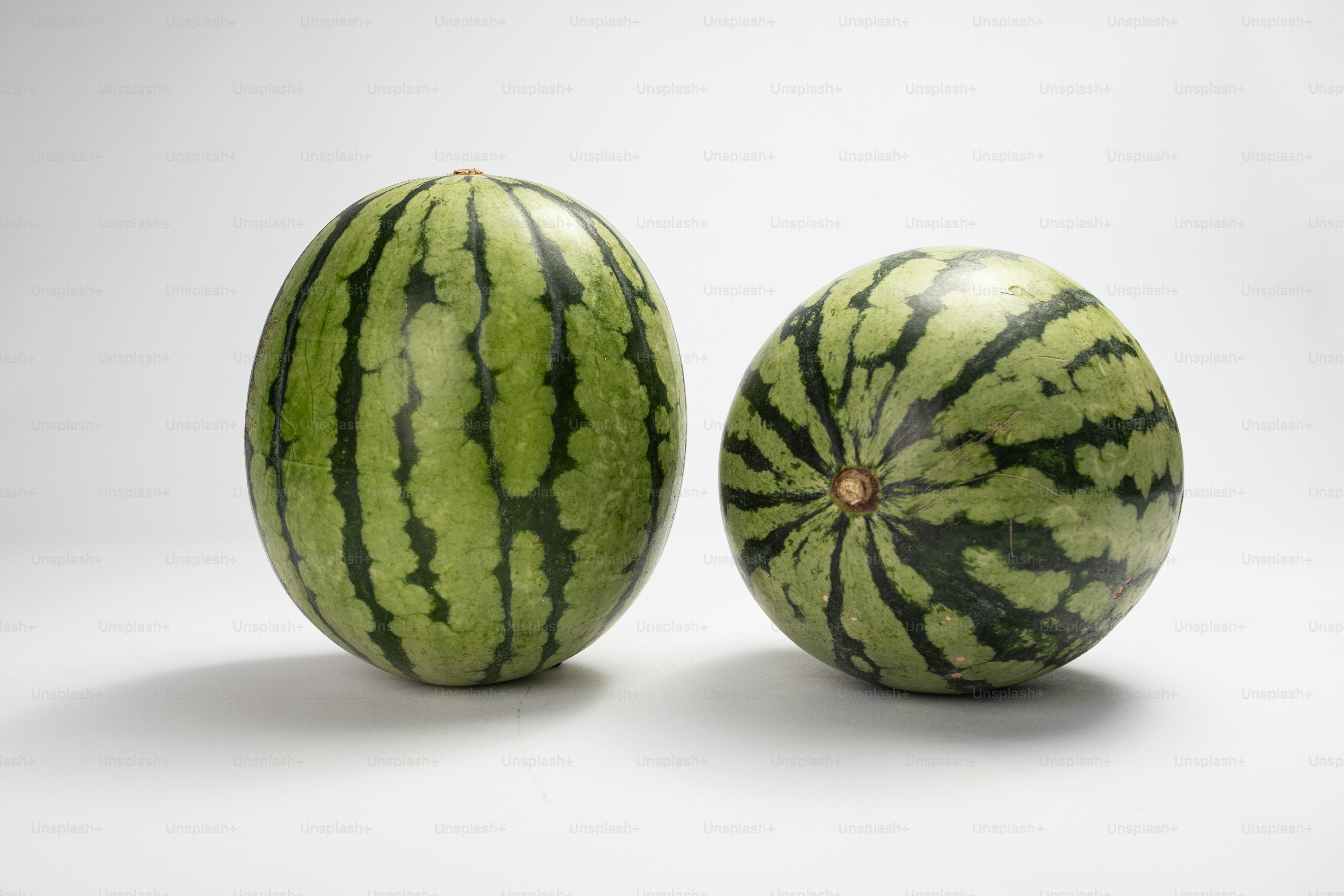 A couple of watermelons sitting next to each other photo – Watermelon ...