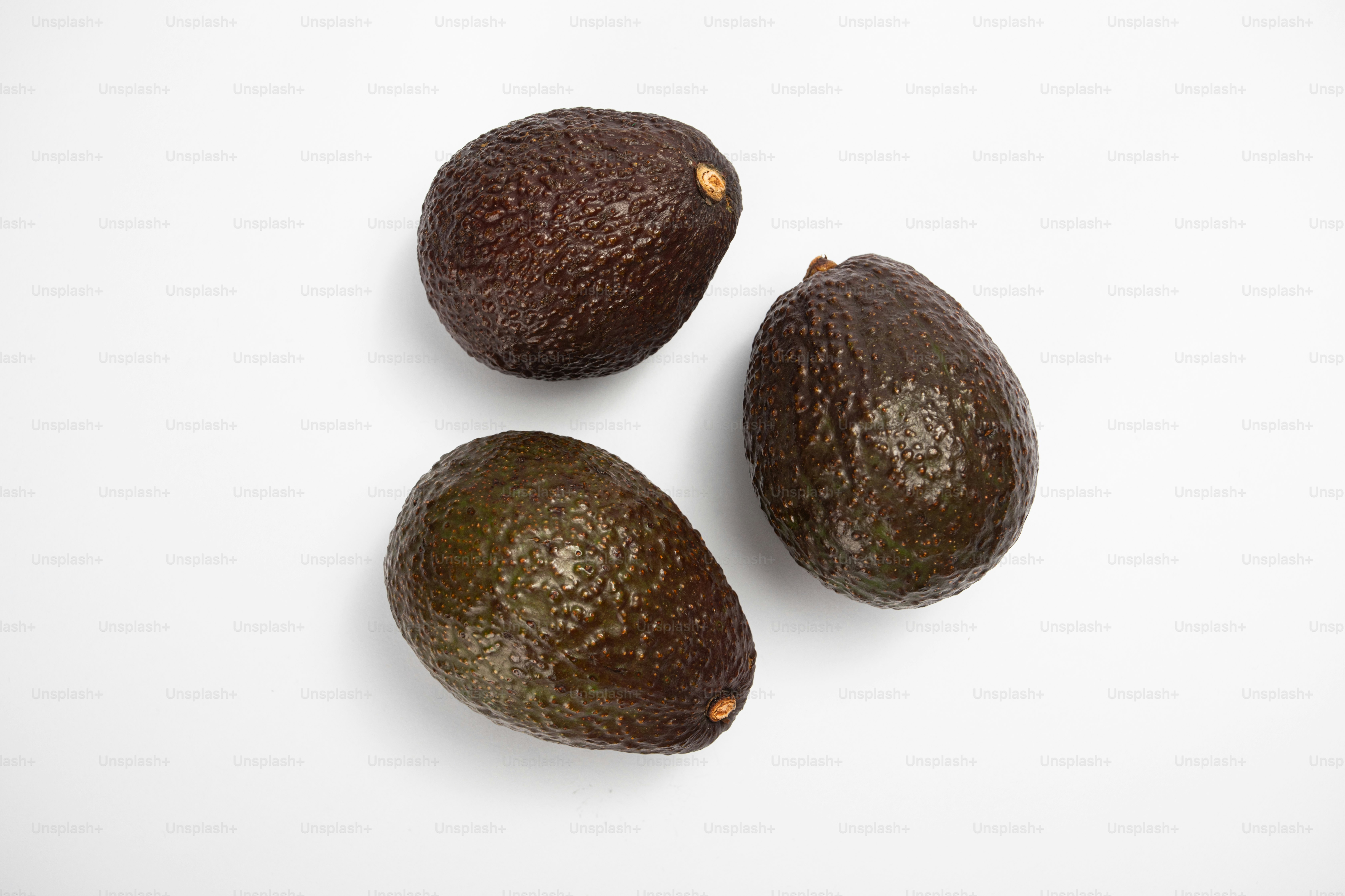 Three avocados sitting on a white surface photo – Avocado Image on Unsplash