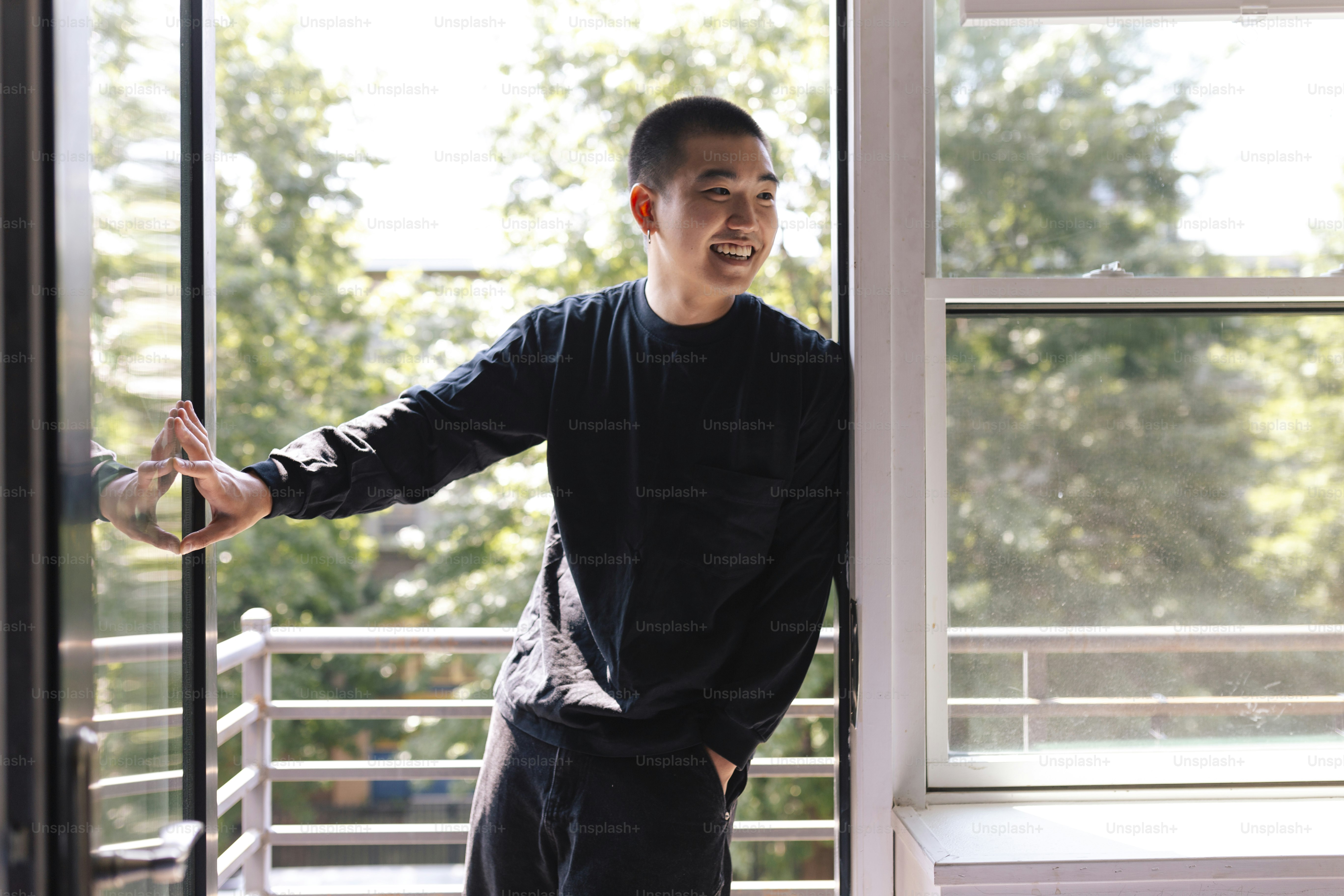 A man standing in front of a window smiling