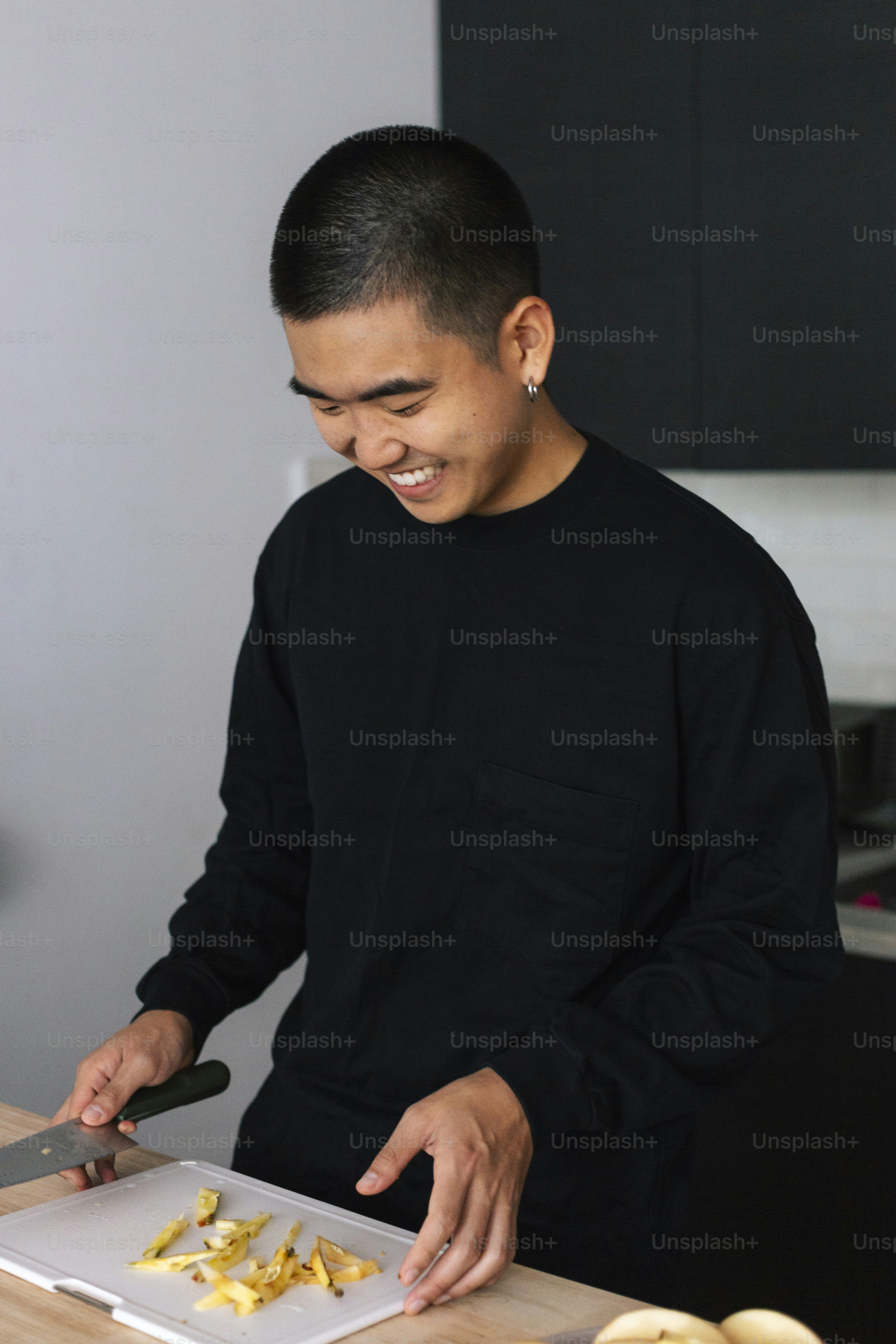 A man cutting up food on a cutting board