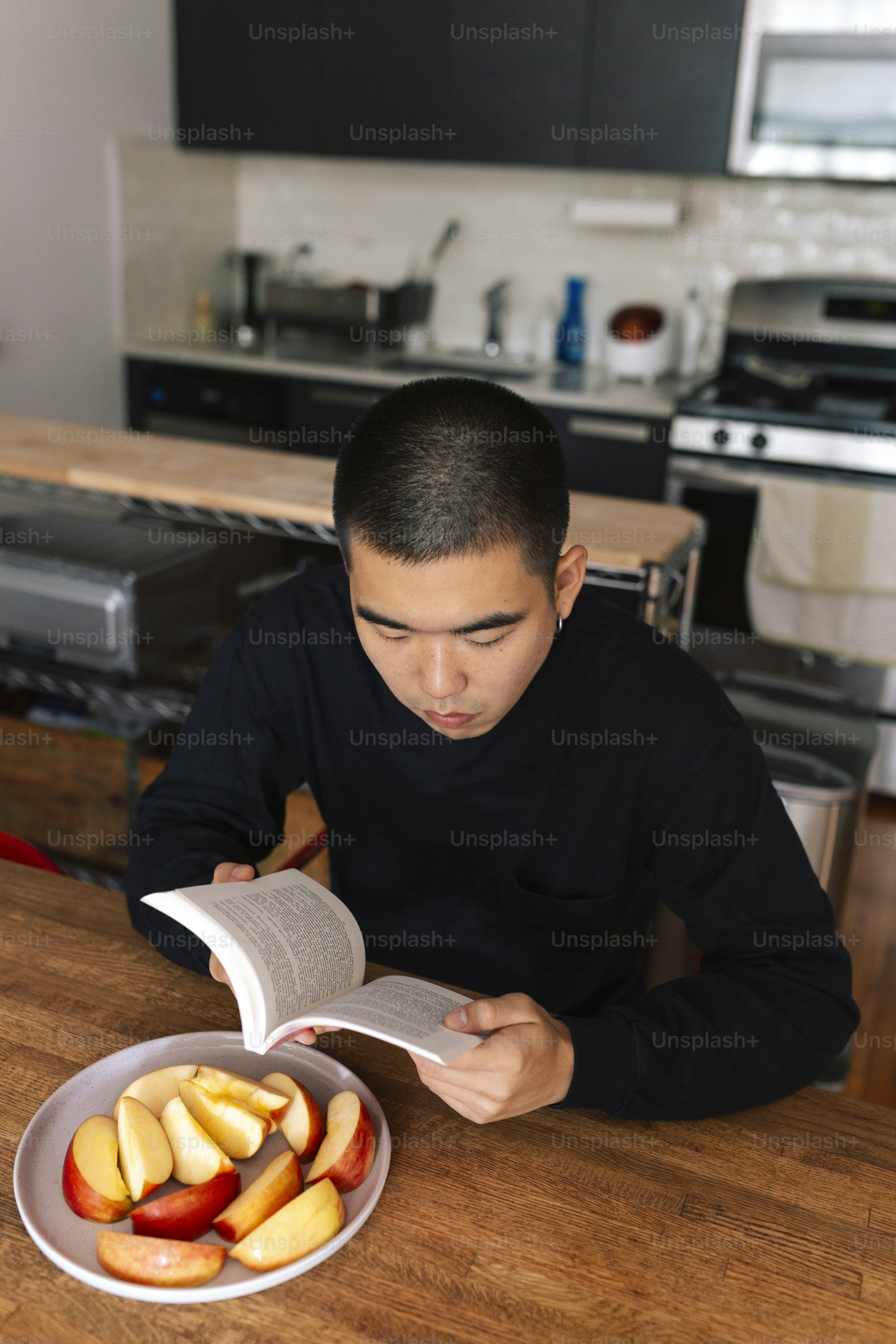 A man sitting at a table reading a book