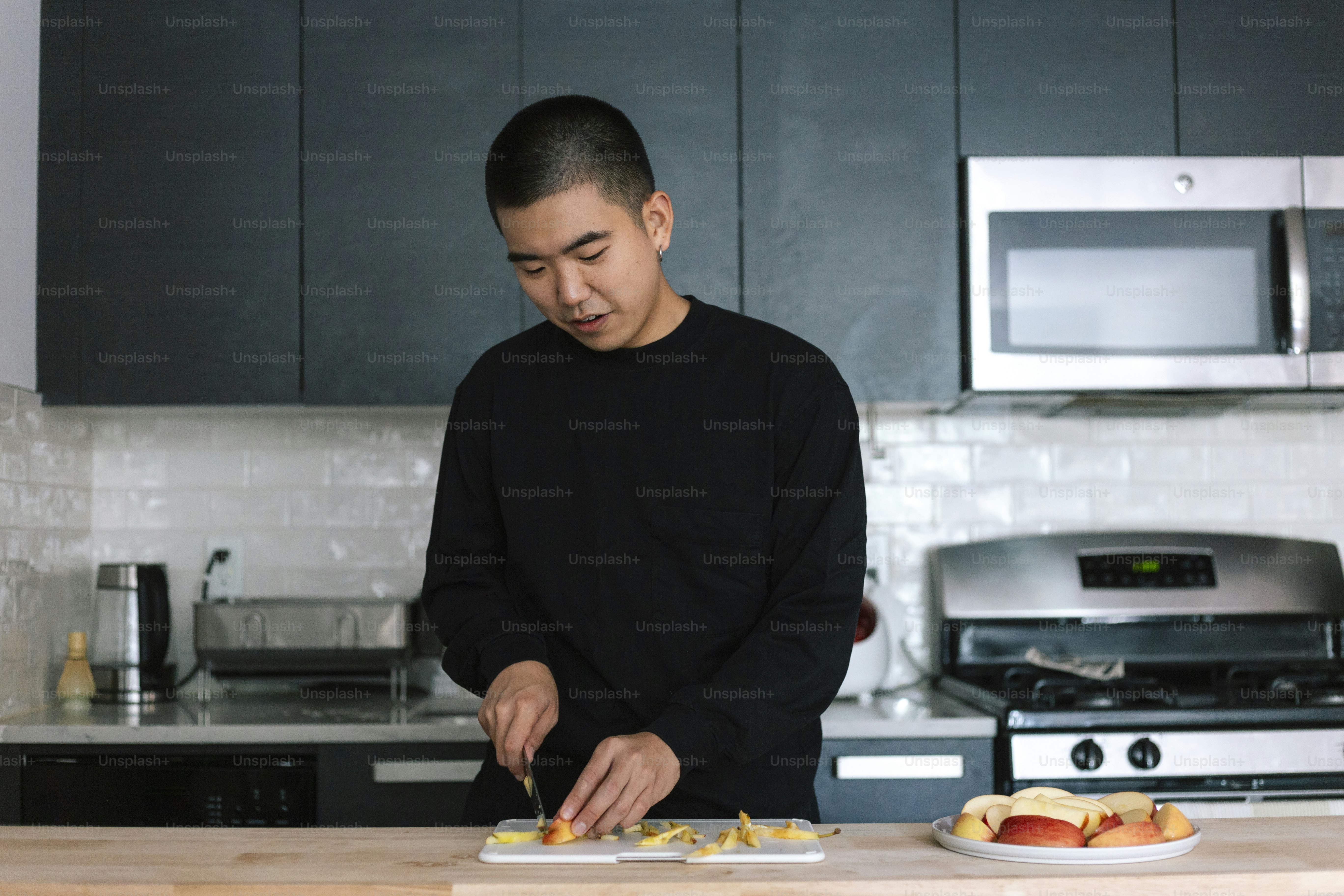 A man standing in a kitchen preparing food