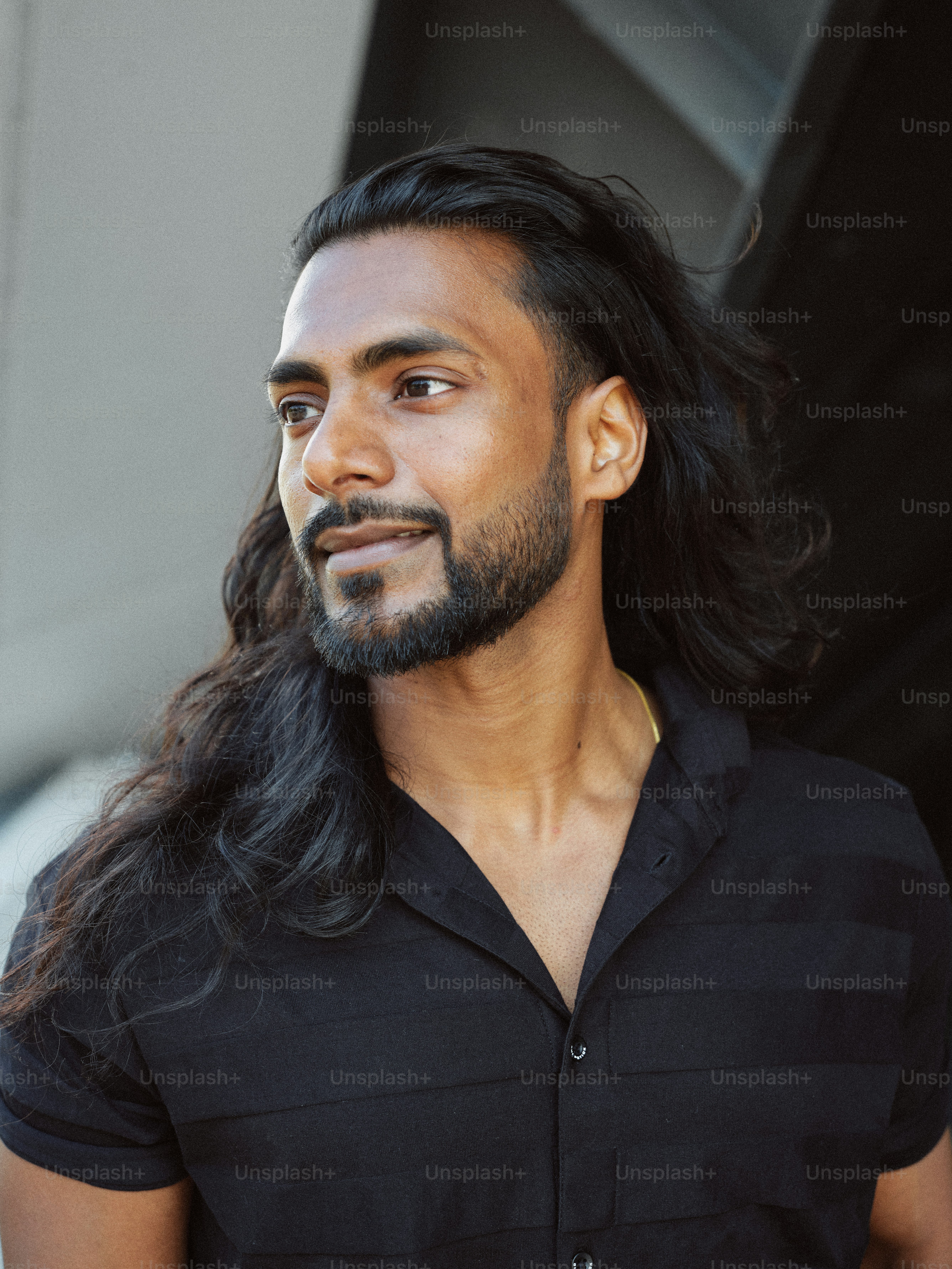 A man with long hair wearing a black shirt