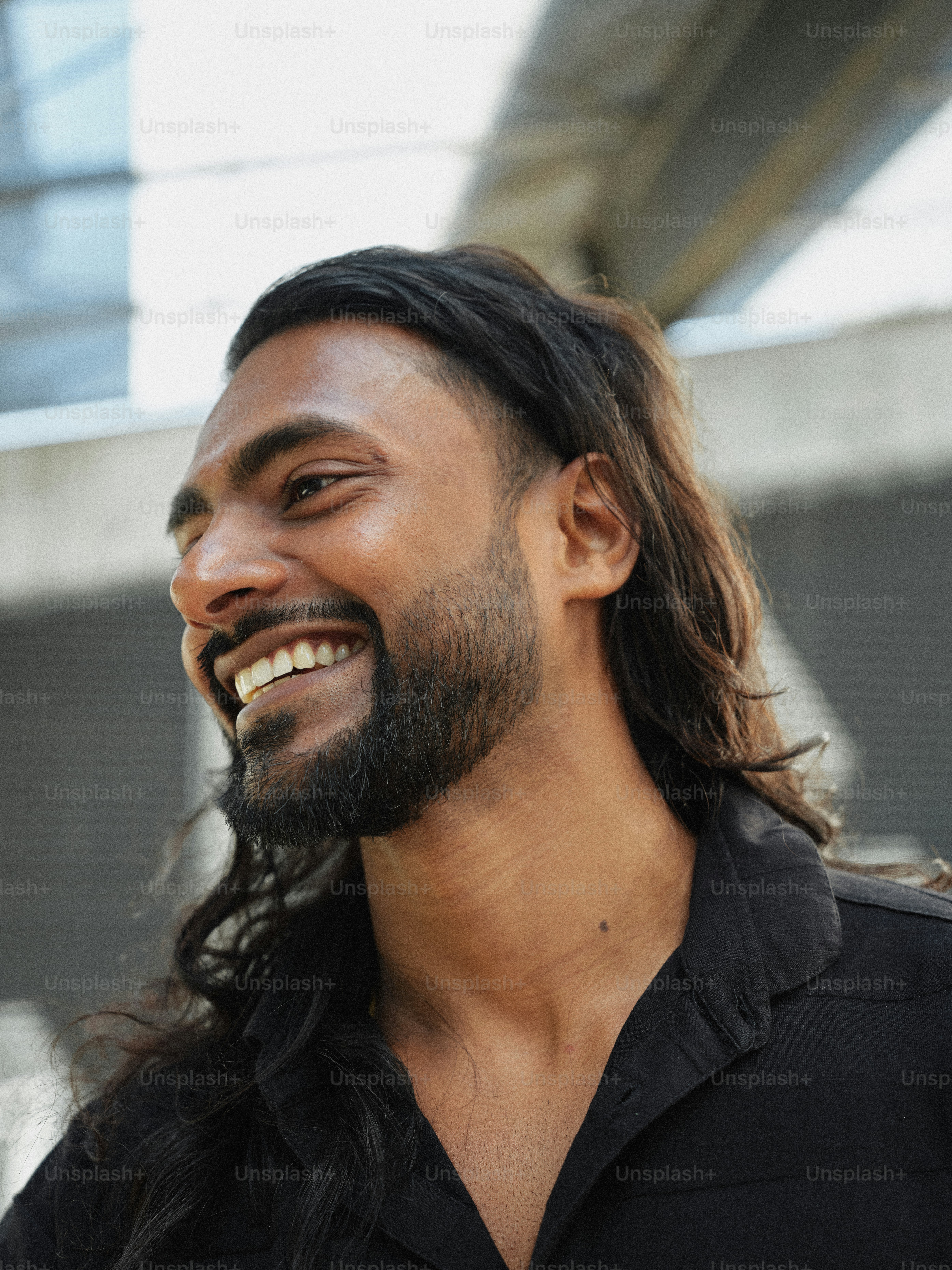 A man with long hair and a beard smiling photo – Indian man Image on ...