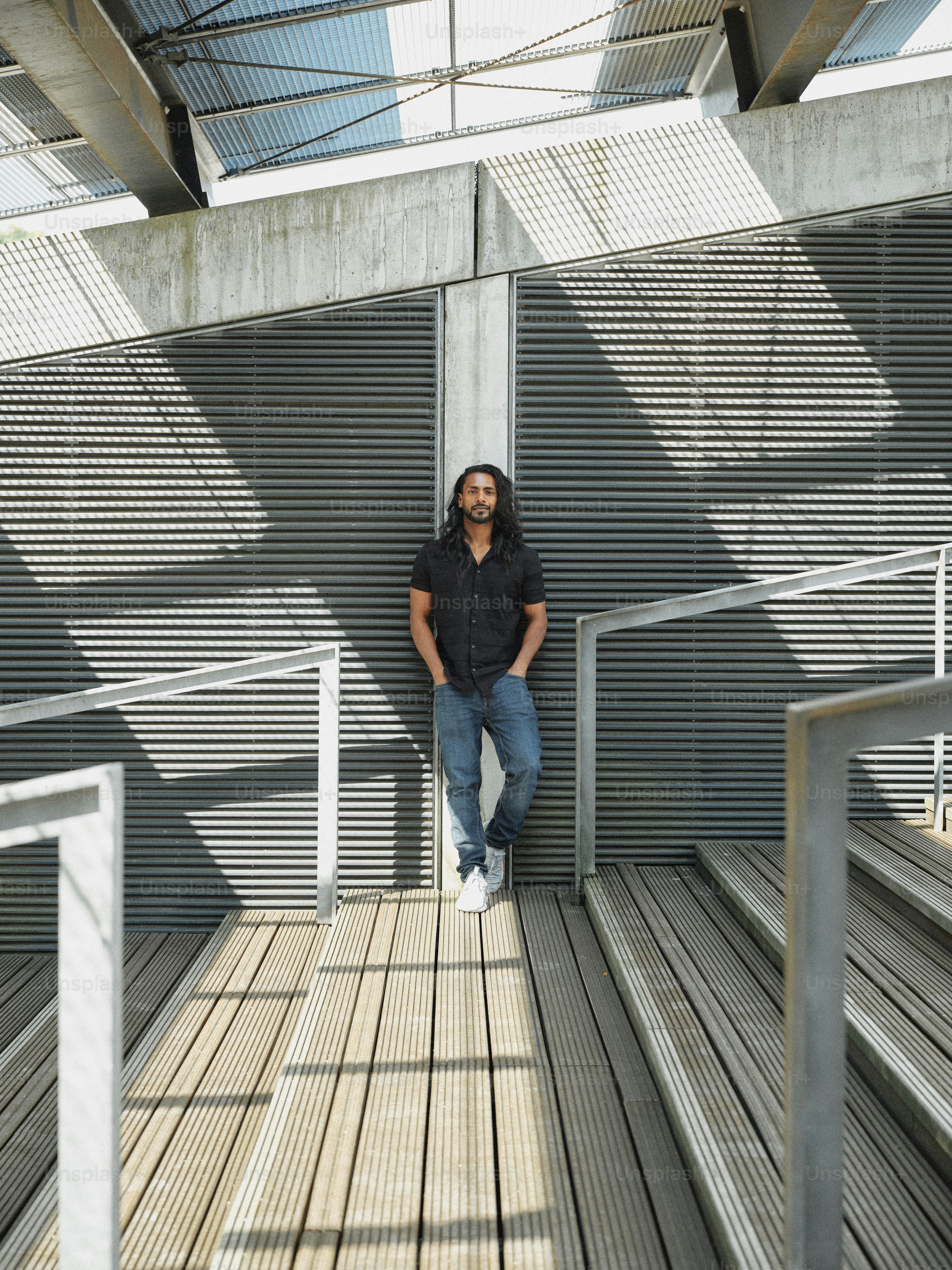 A man leaning against a wall in a building