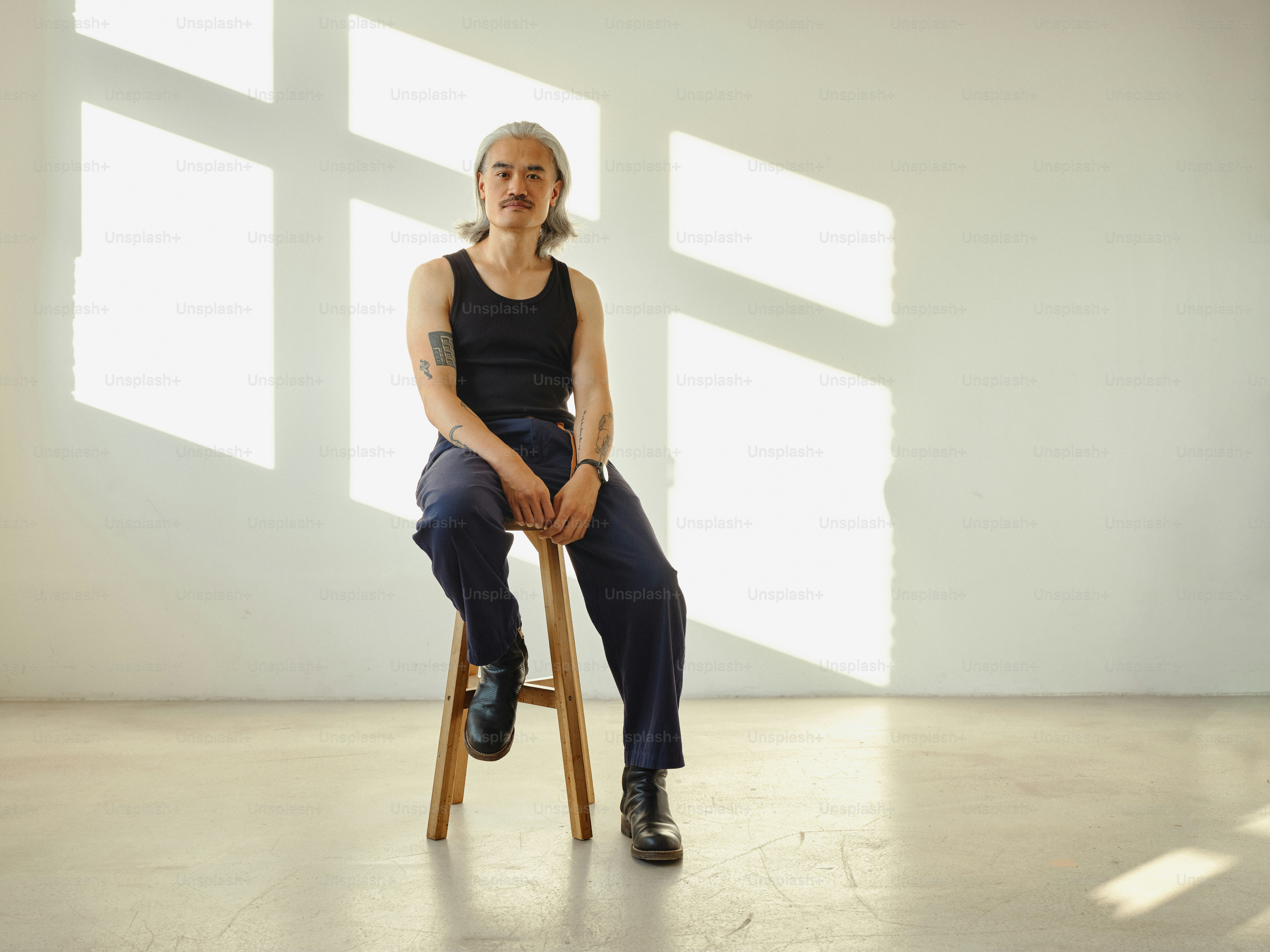 A woman sitting on top of a wooden stool