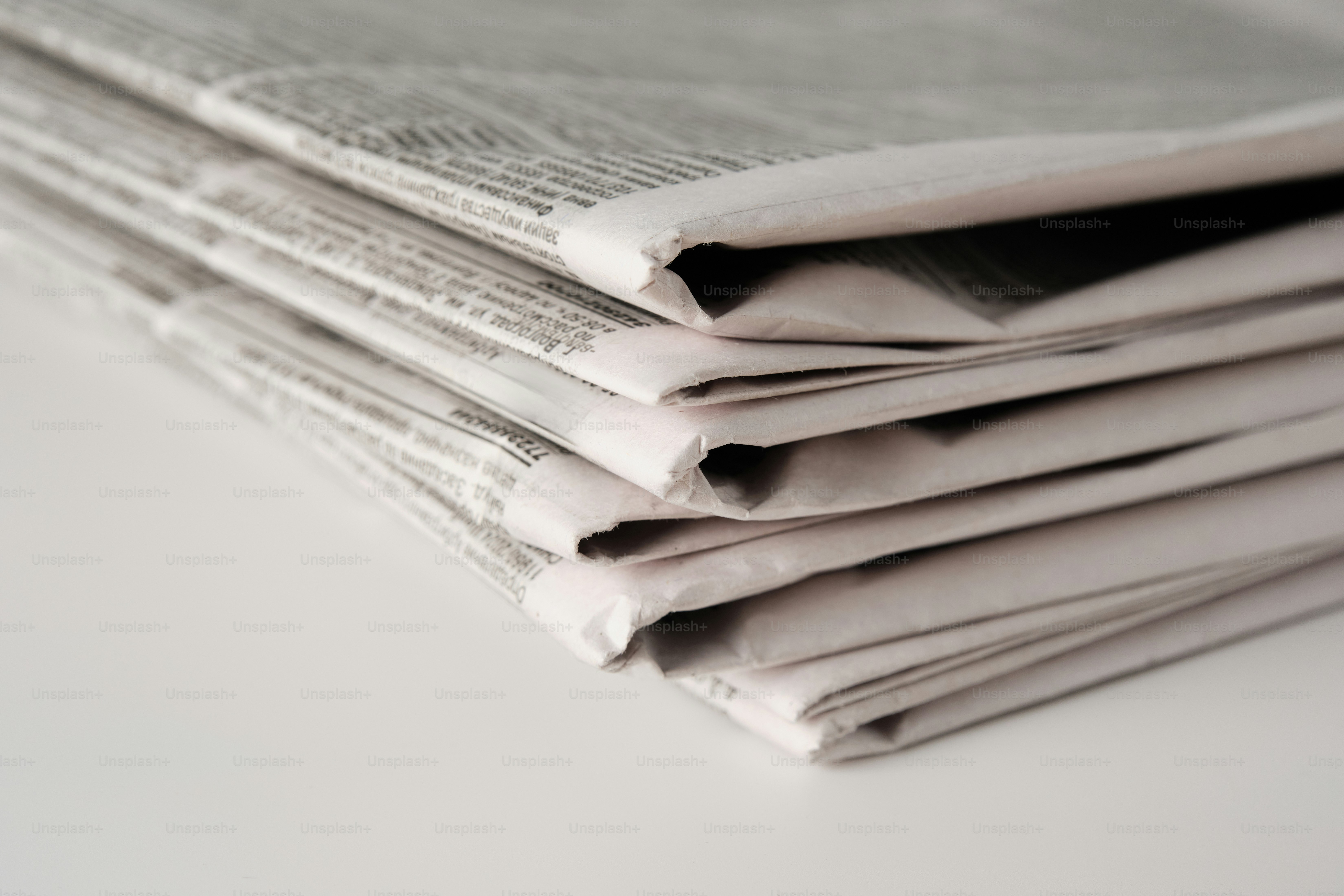 A stack of newspapers stacked on top of each other