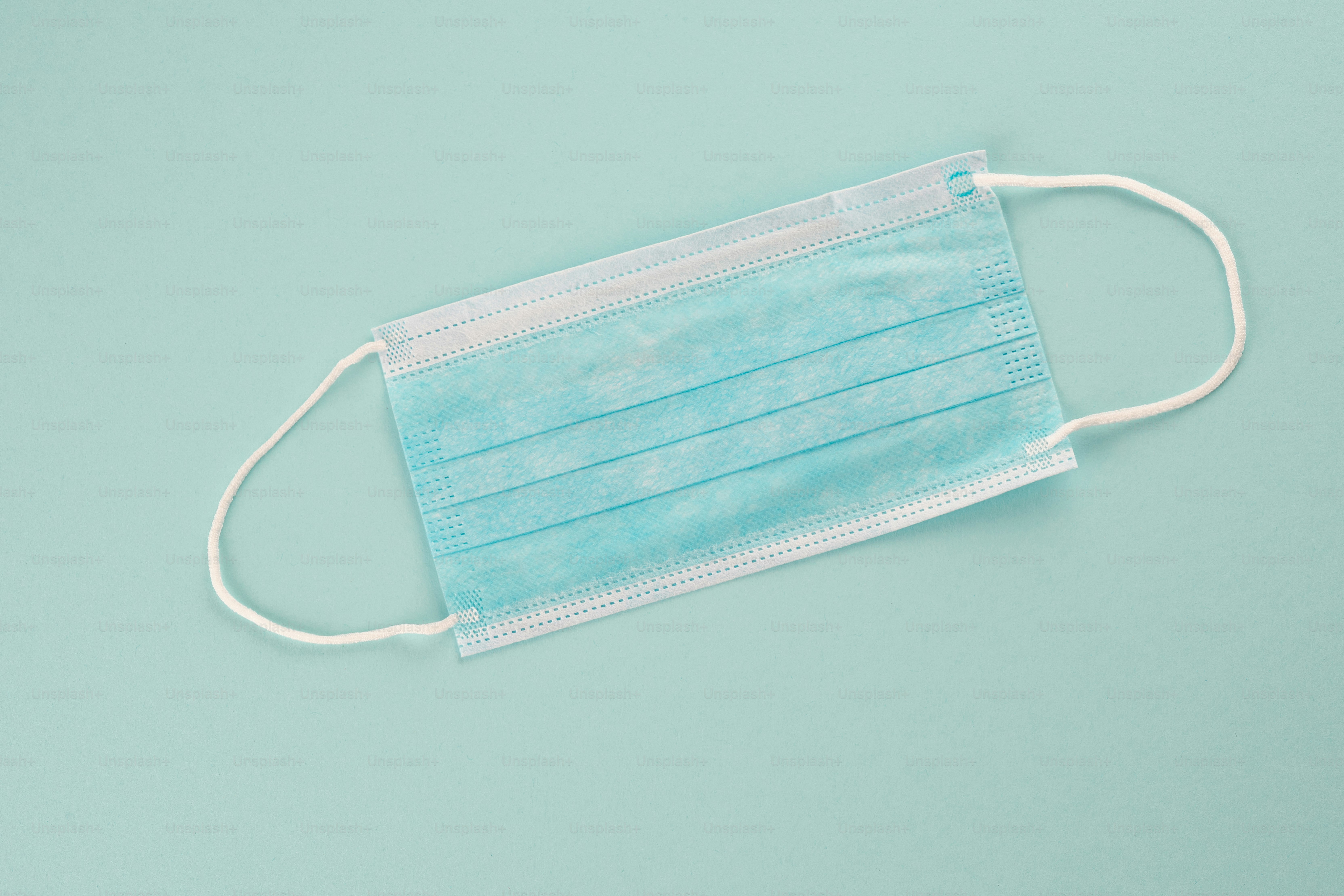 A surgical mask on a blue background