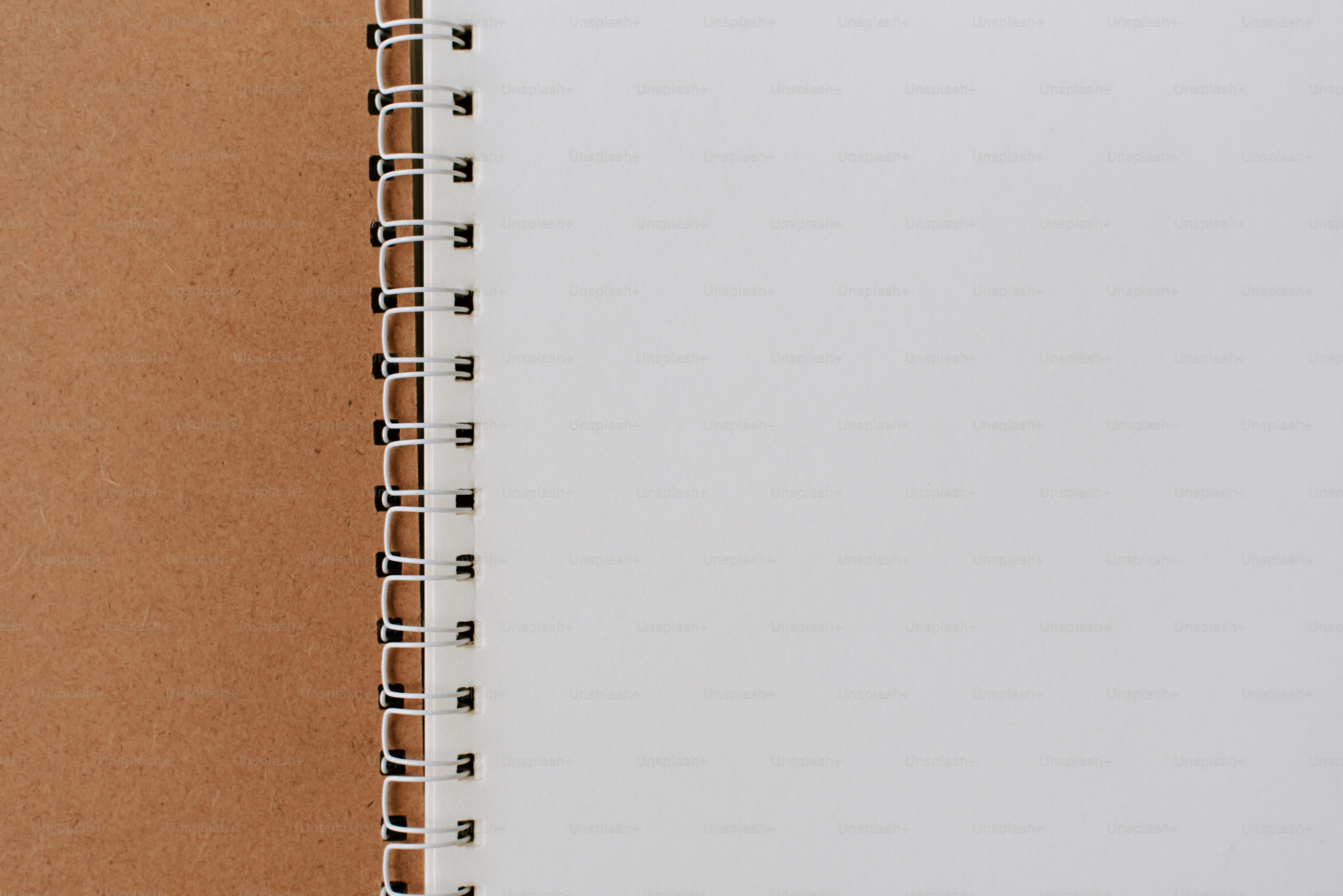 A notebook with a pen on top of it