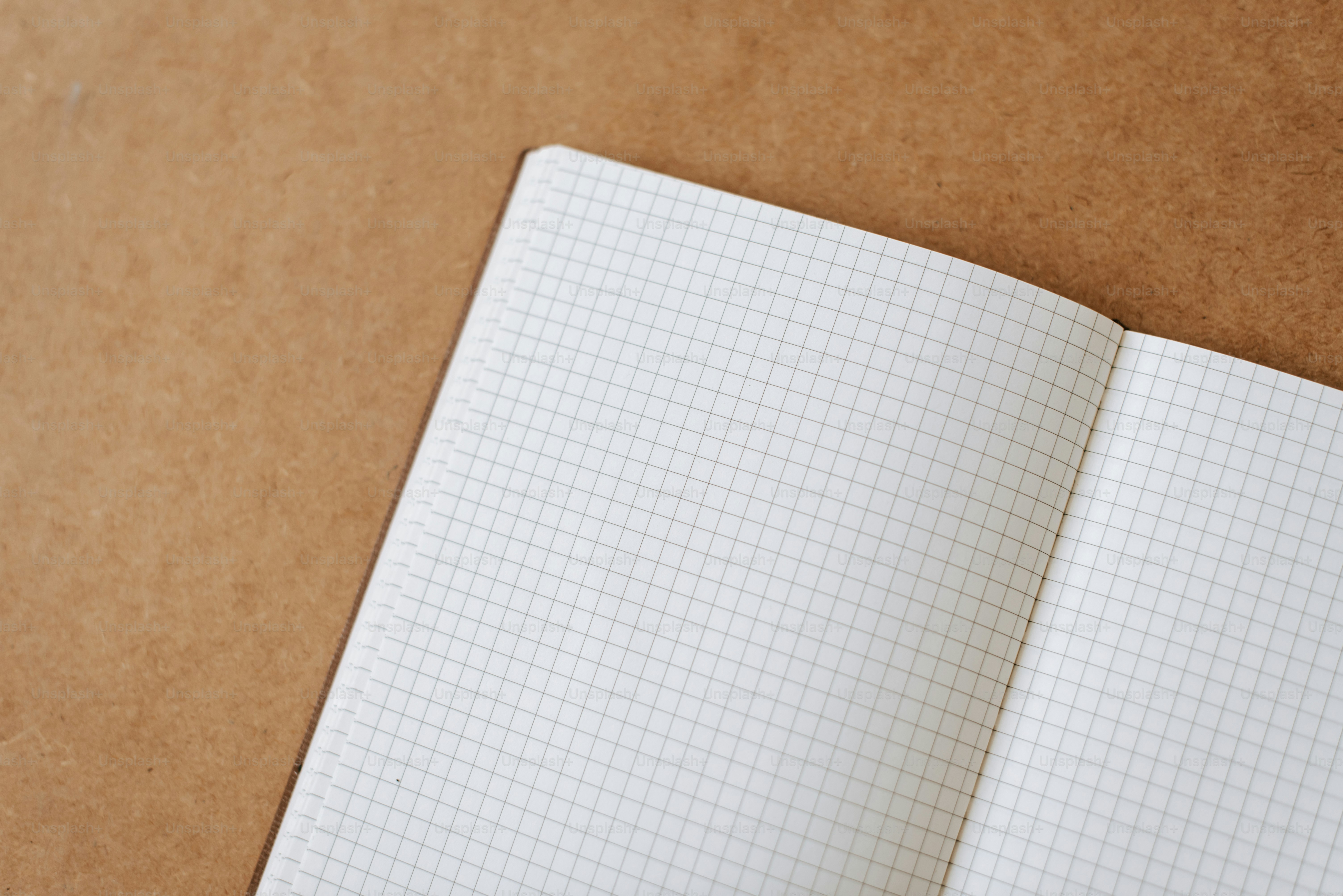 An open notebook with a pen on top of it