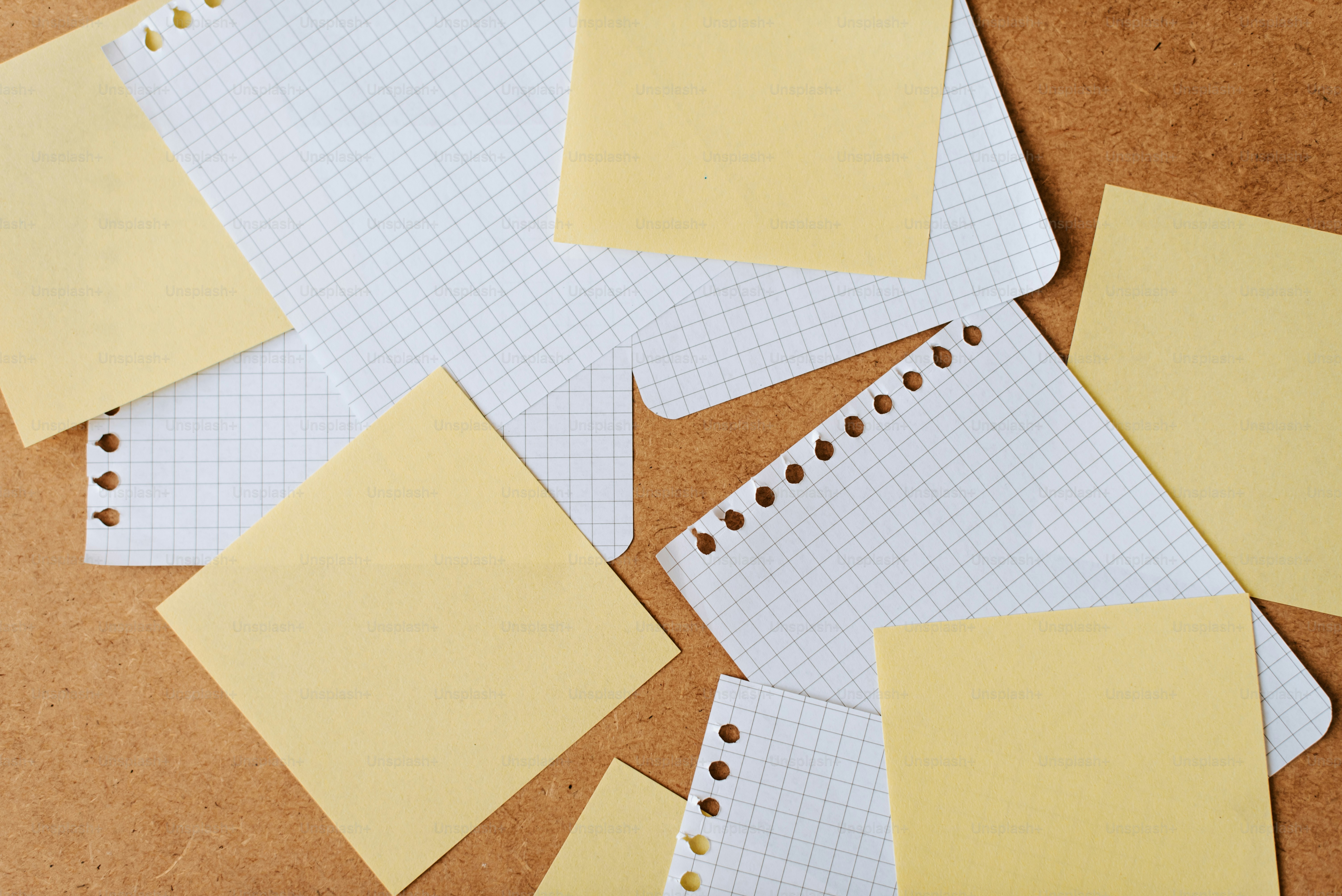 A pile of yellow sticky notes on top of a table