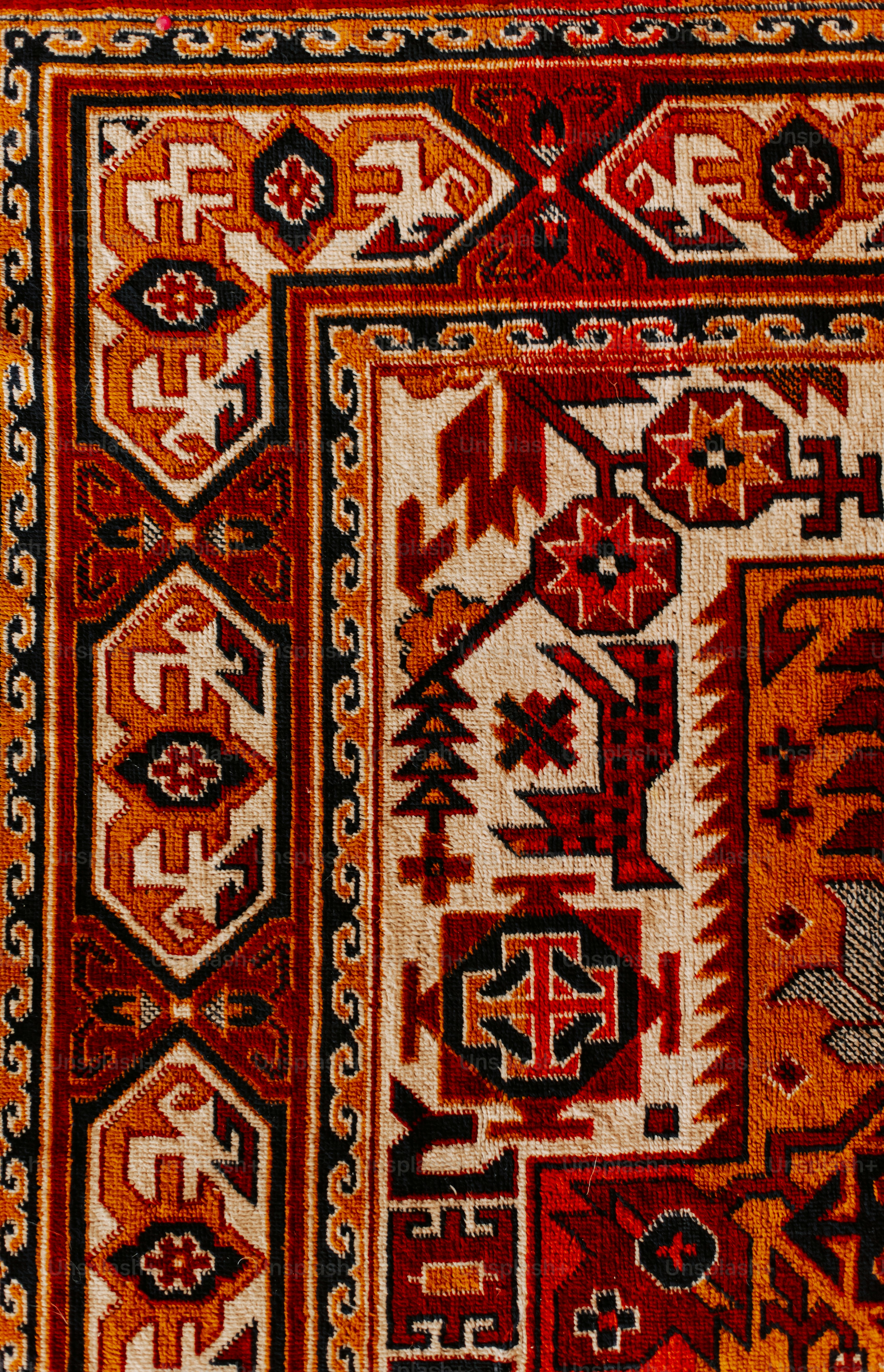 A red and yellow rug with a design on it photo Patterns Image on Unsplash