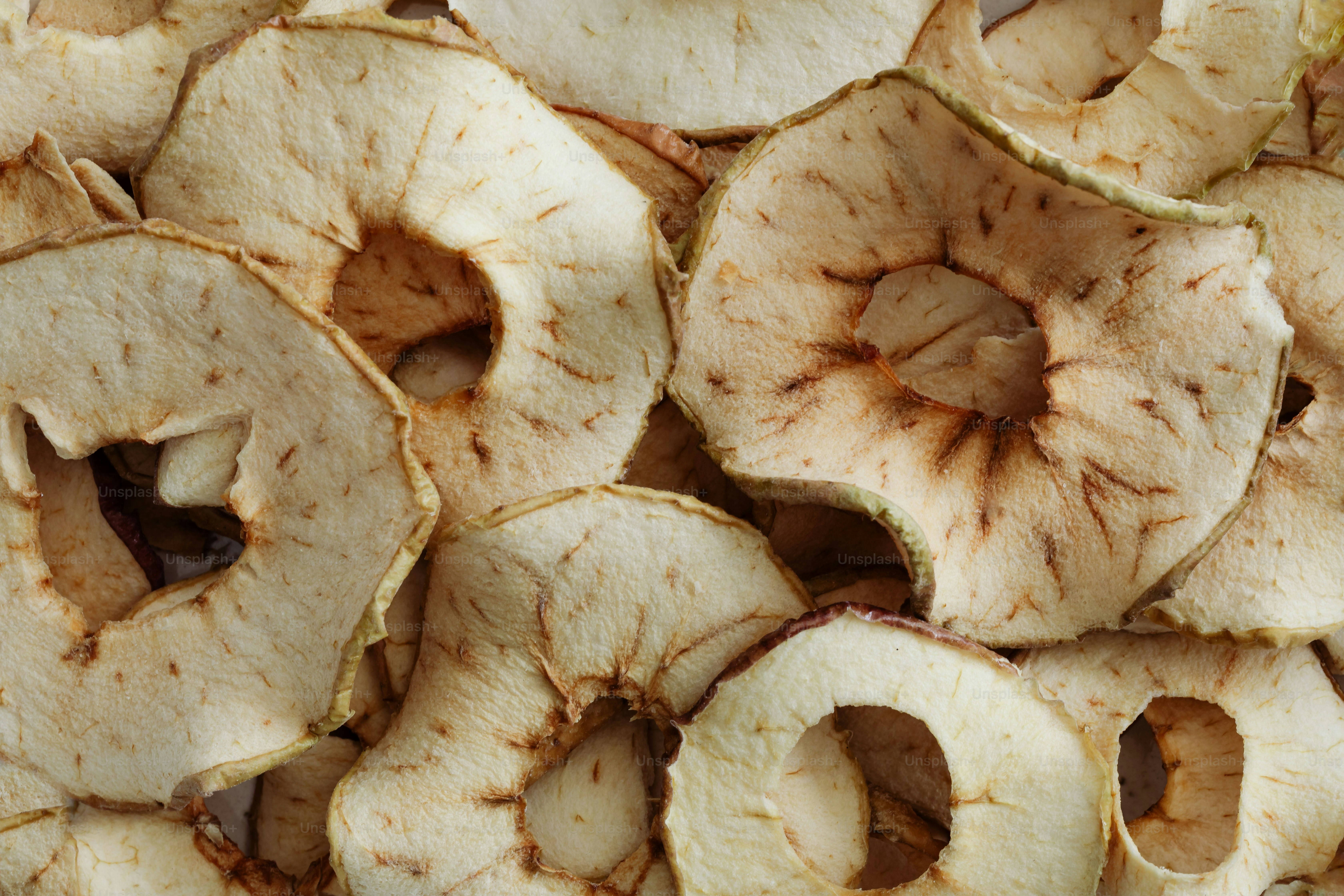A pile of sliced apples sitting on top of a table