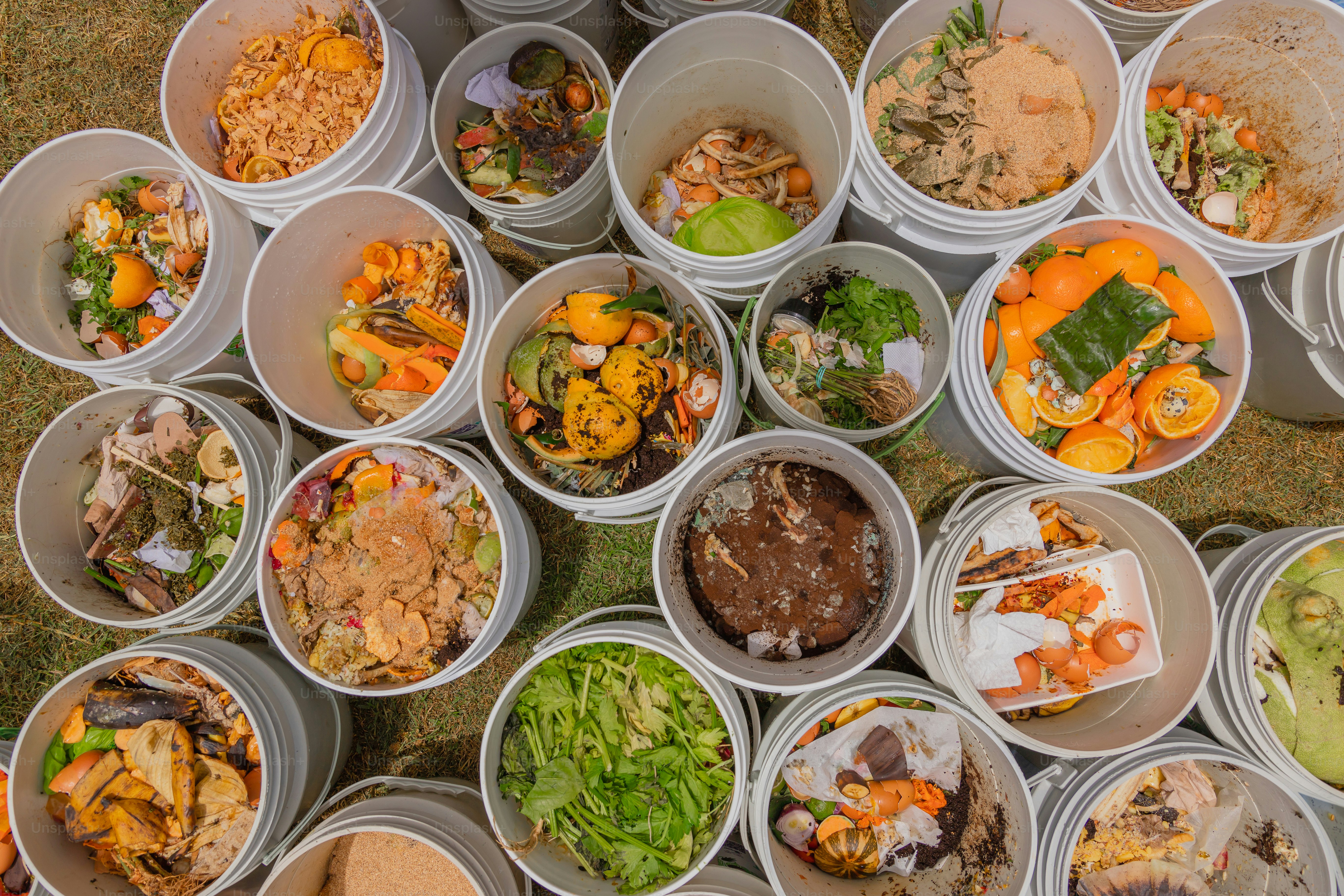 A table topped with lots of plastic containers filled with food