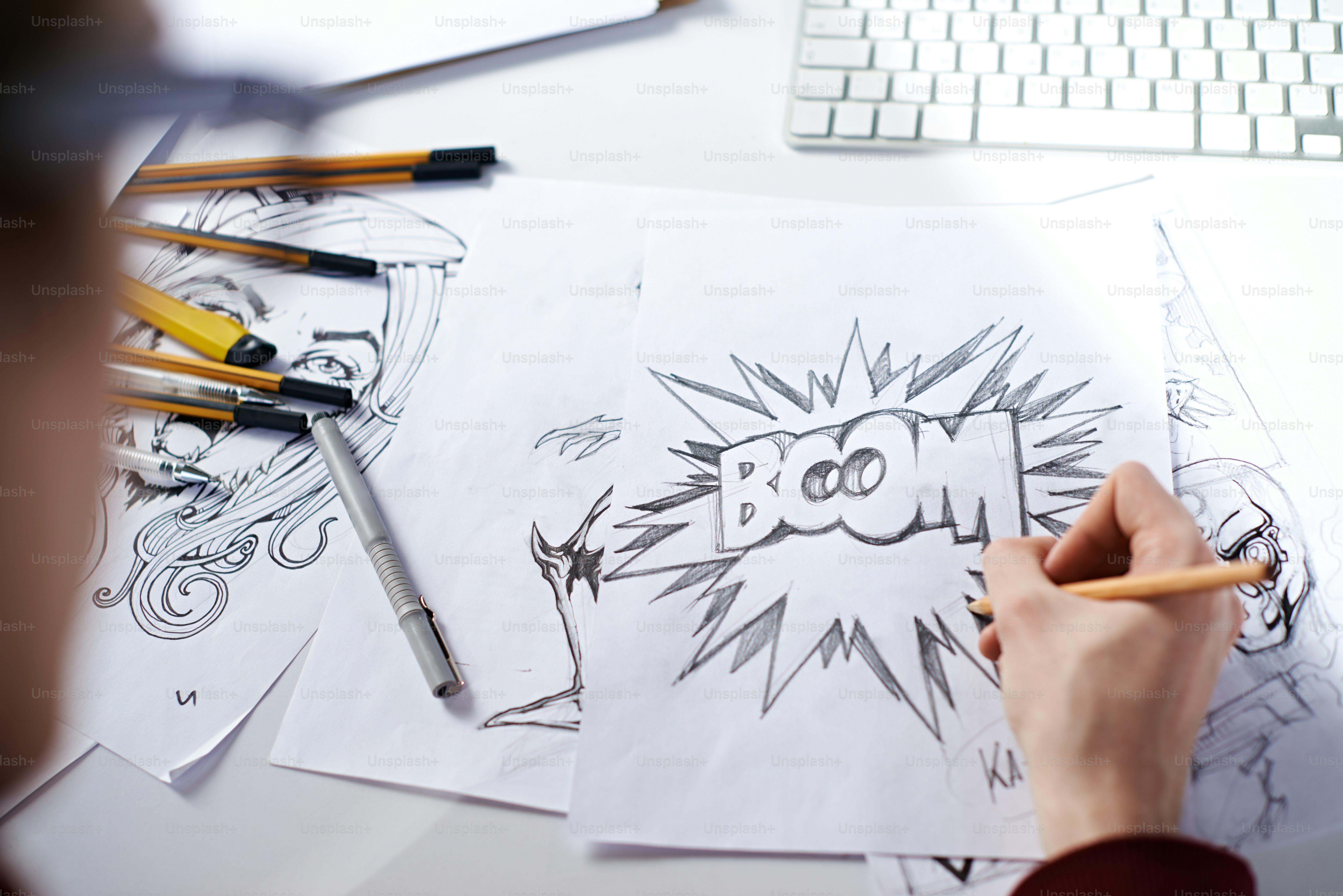 Artist drawing picture with word: "Boom!"