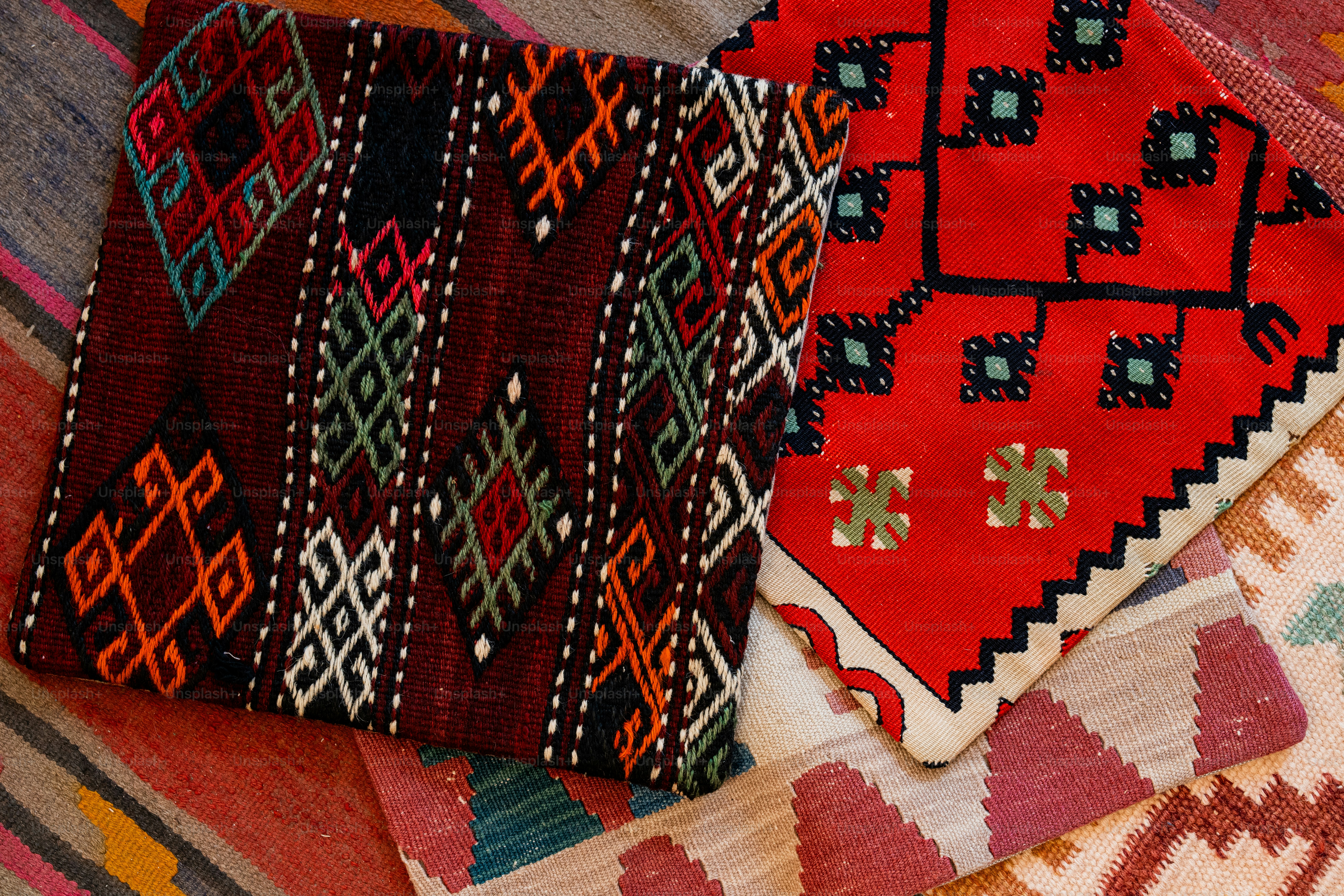 A pile of colorful rugs sitting on top of a floor