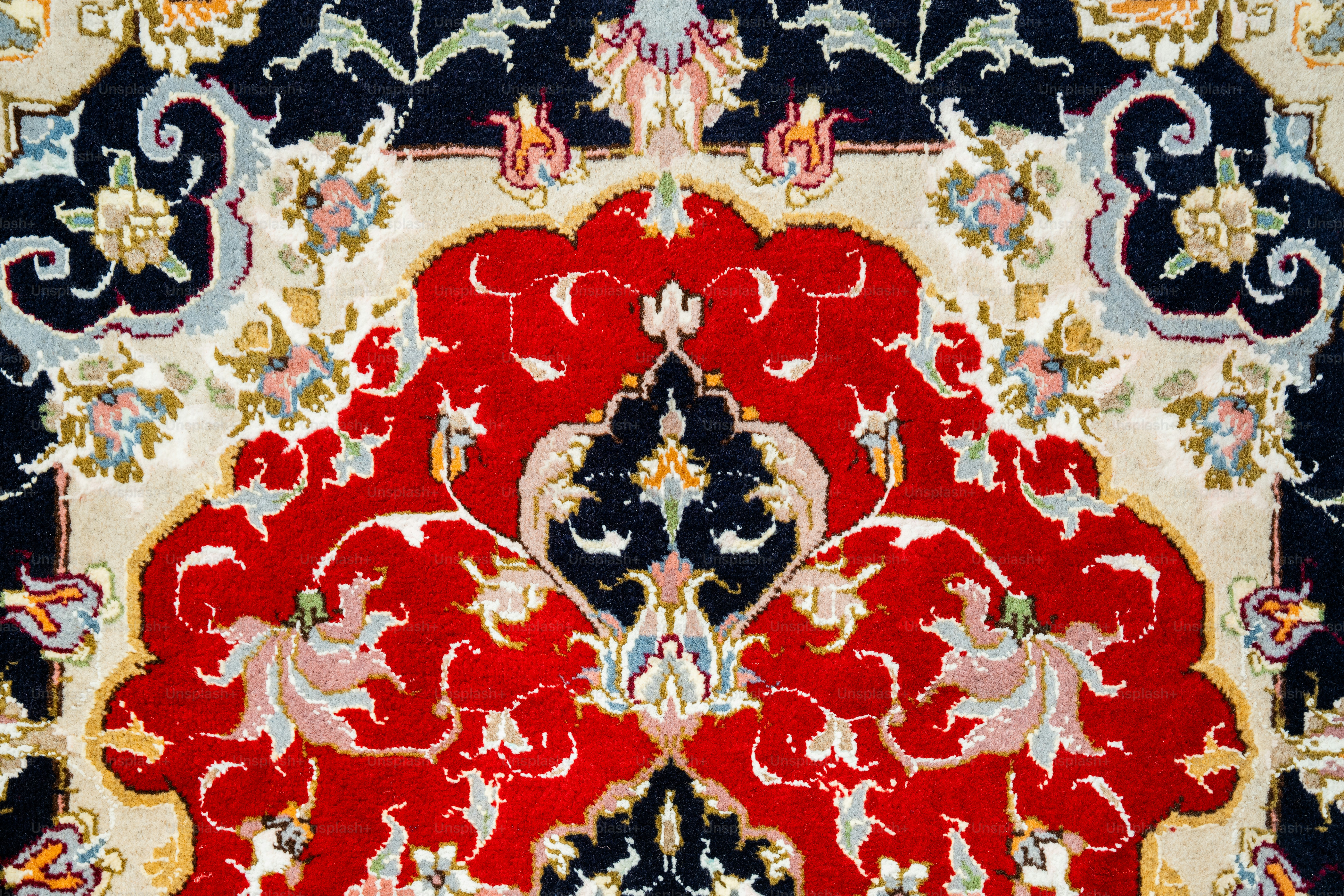 A red, blue, and white rug with an ornate design