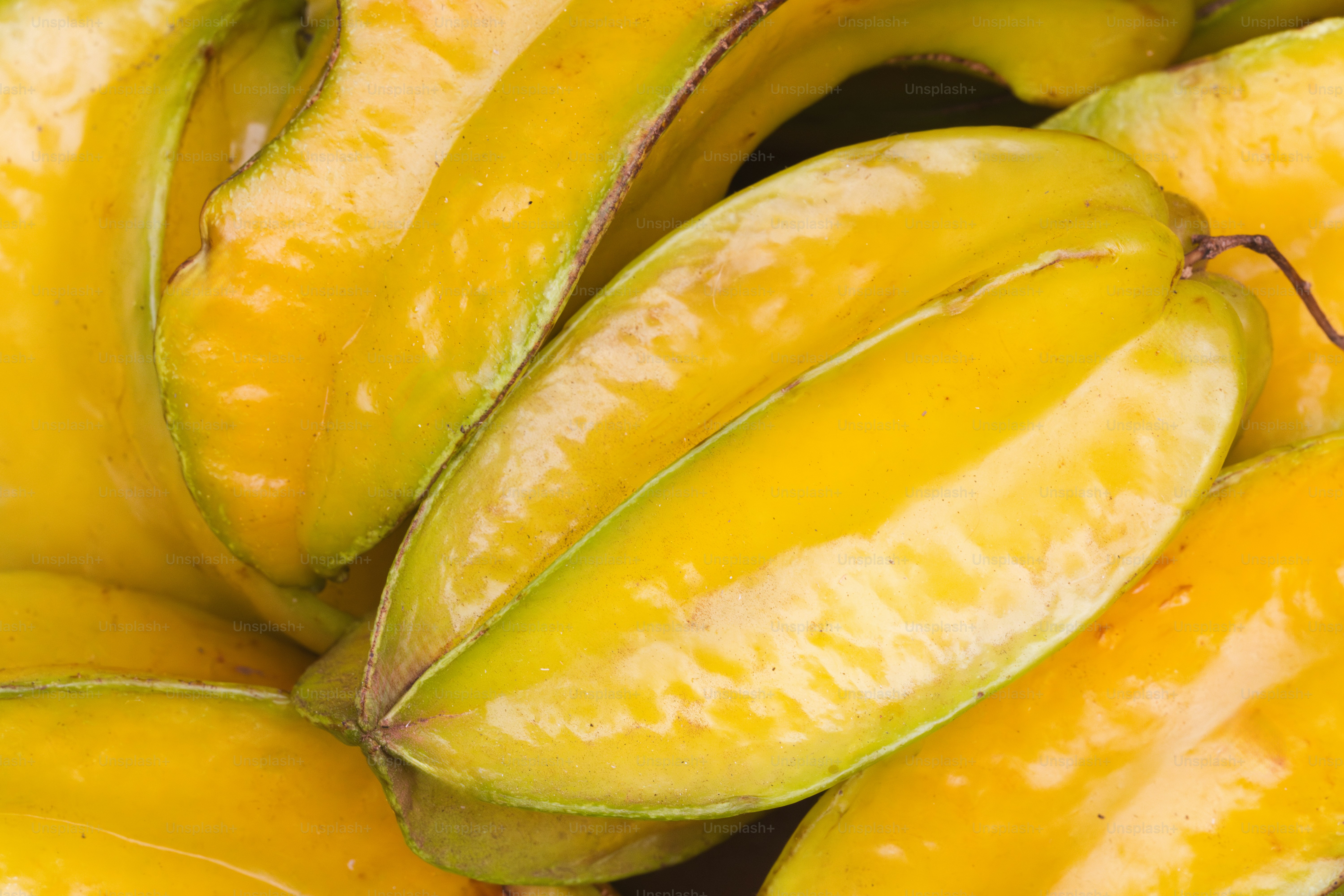 A bunch of yellow bananas sitting on top of each other
