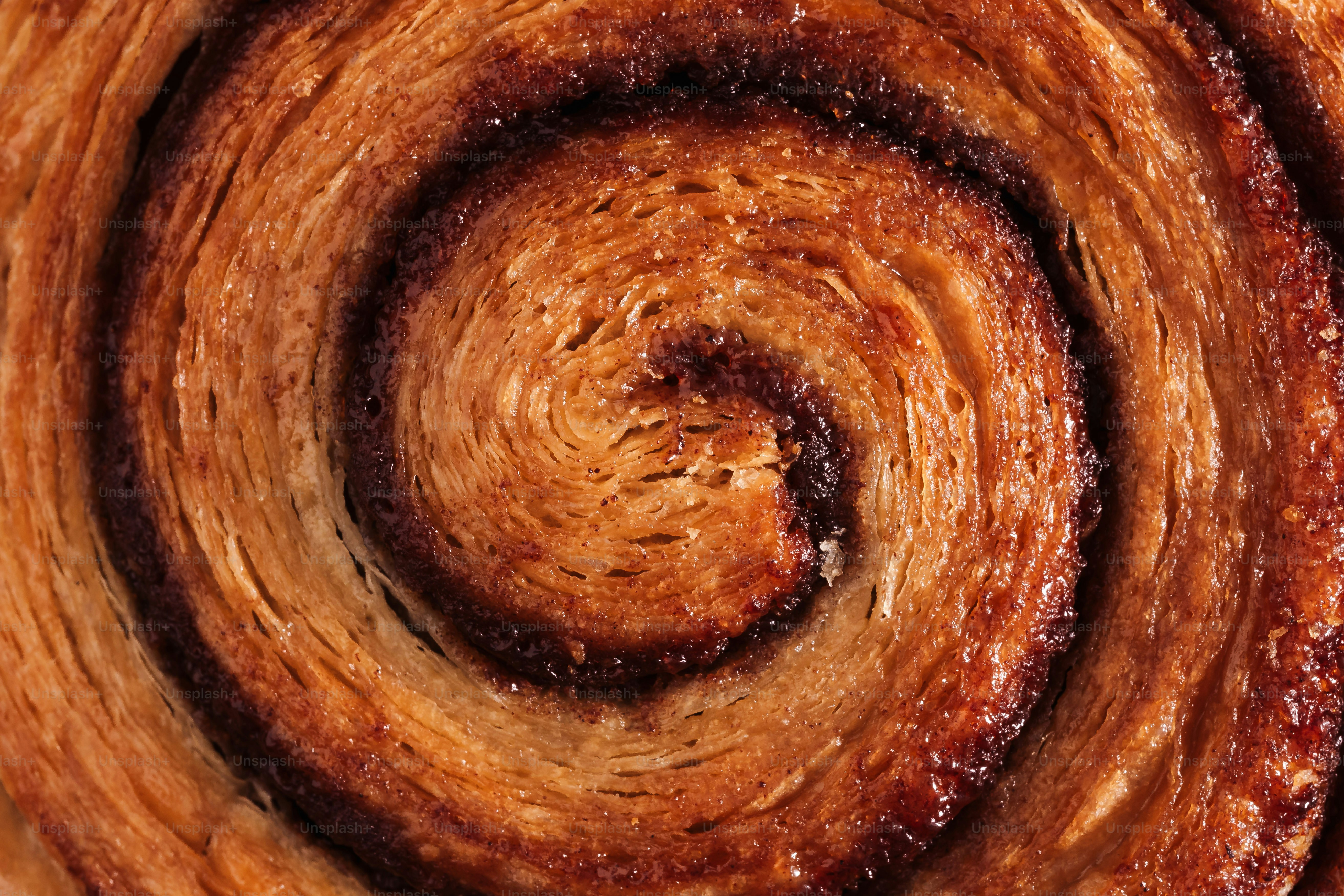 A close up of a cinnamon roll with icing photo – Macro Image on Unsplash
