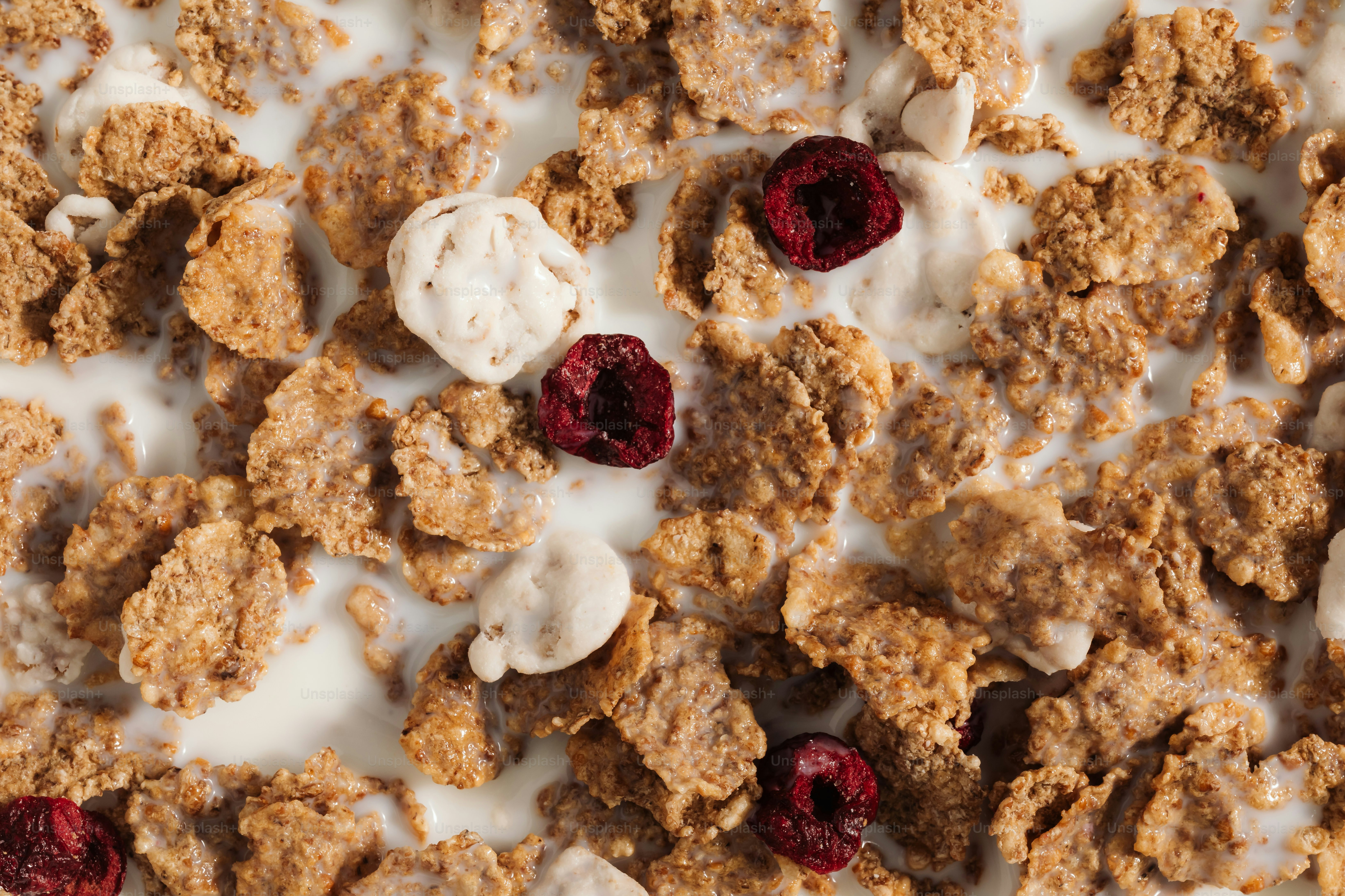 A close up of cereal and berries on a table