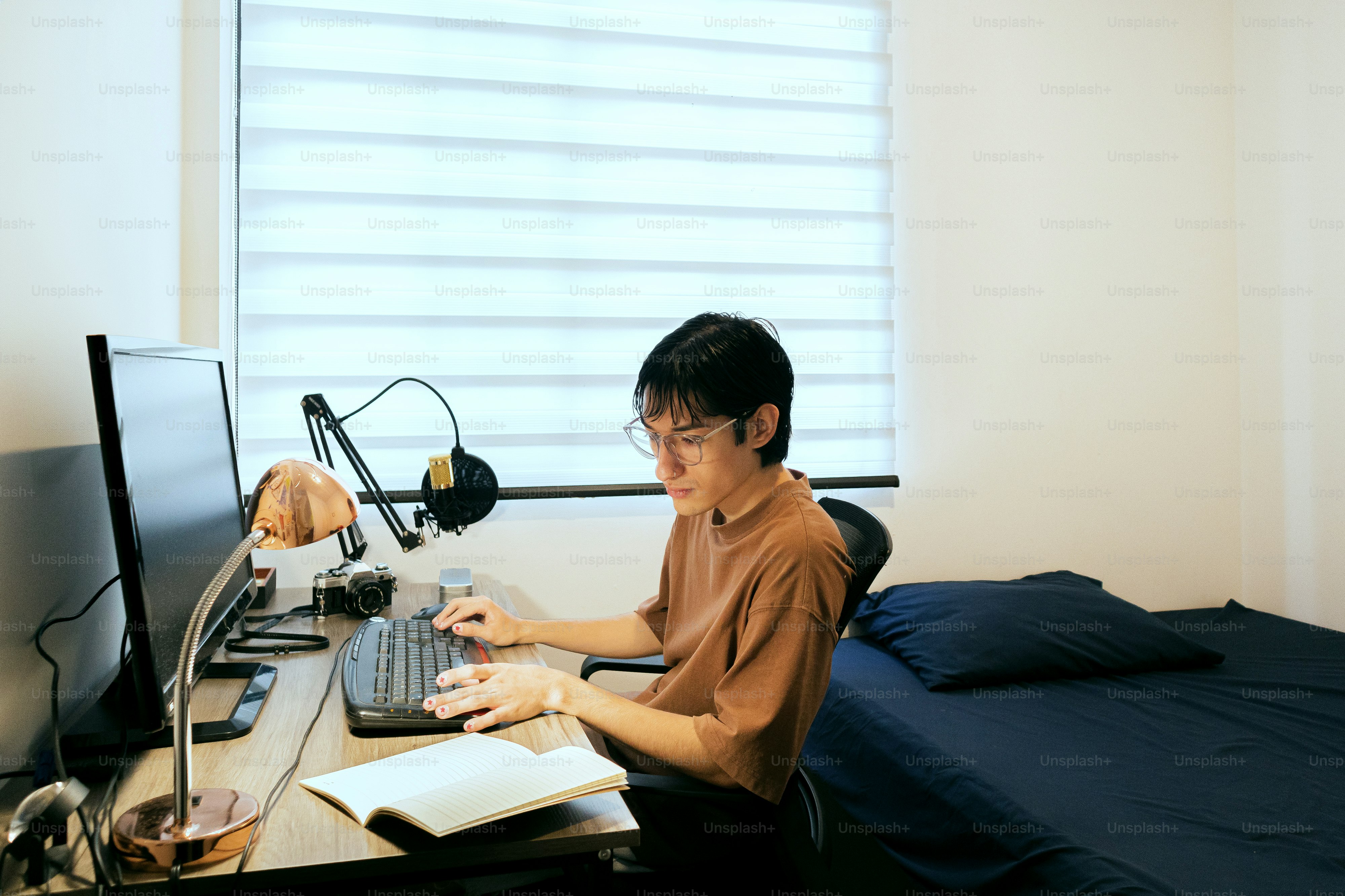 A man sitting at a desk in front of a computer