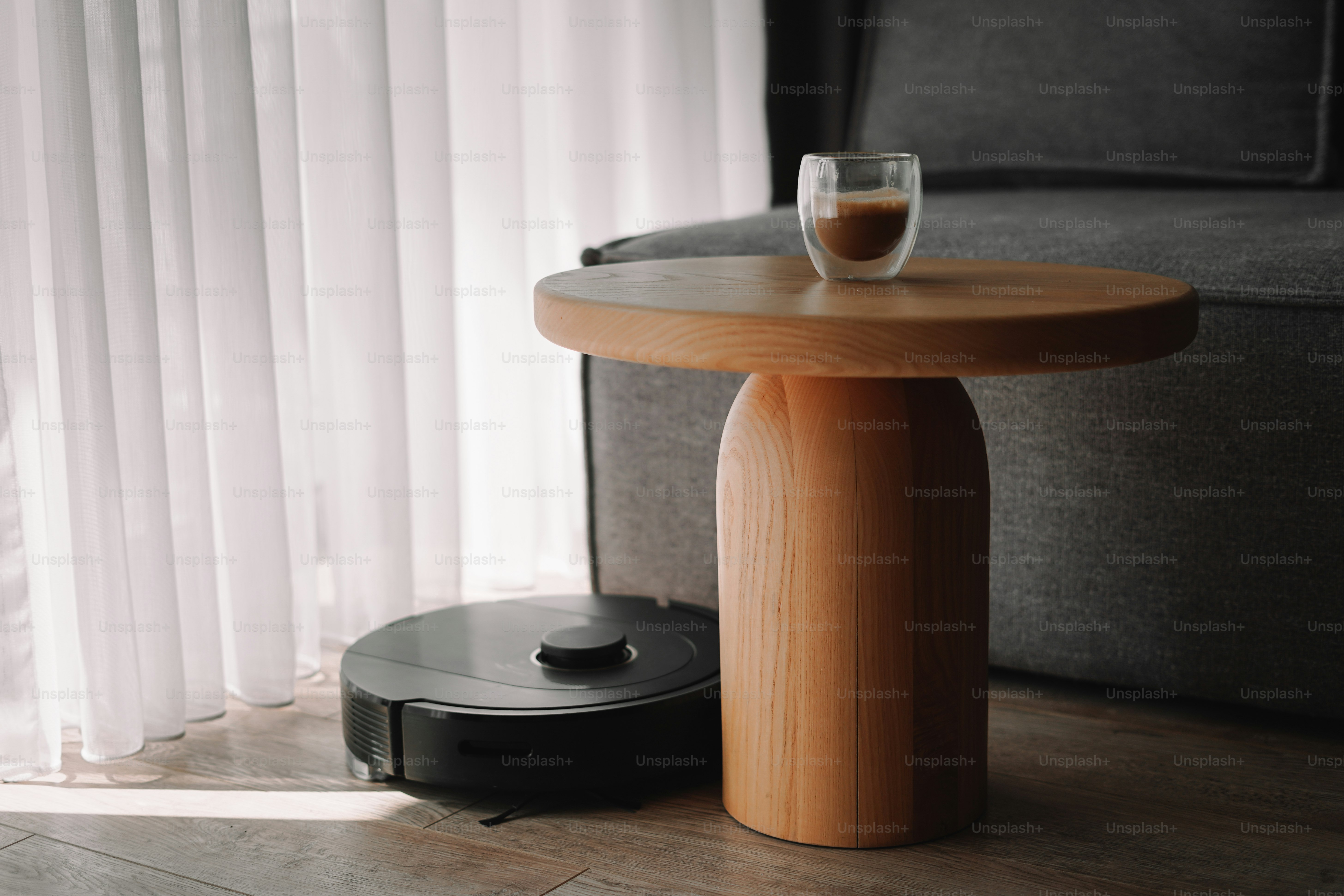 A room with a couch and a table with a coffee cup on it