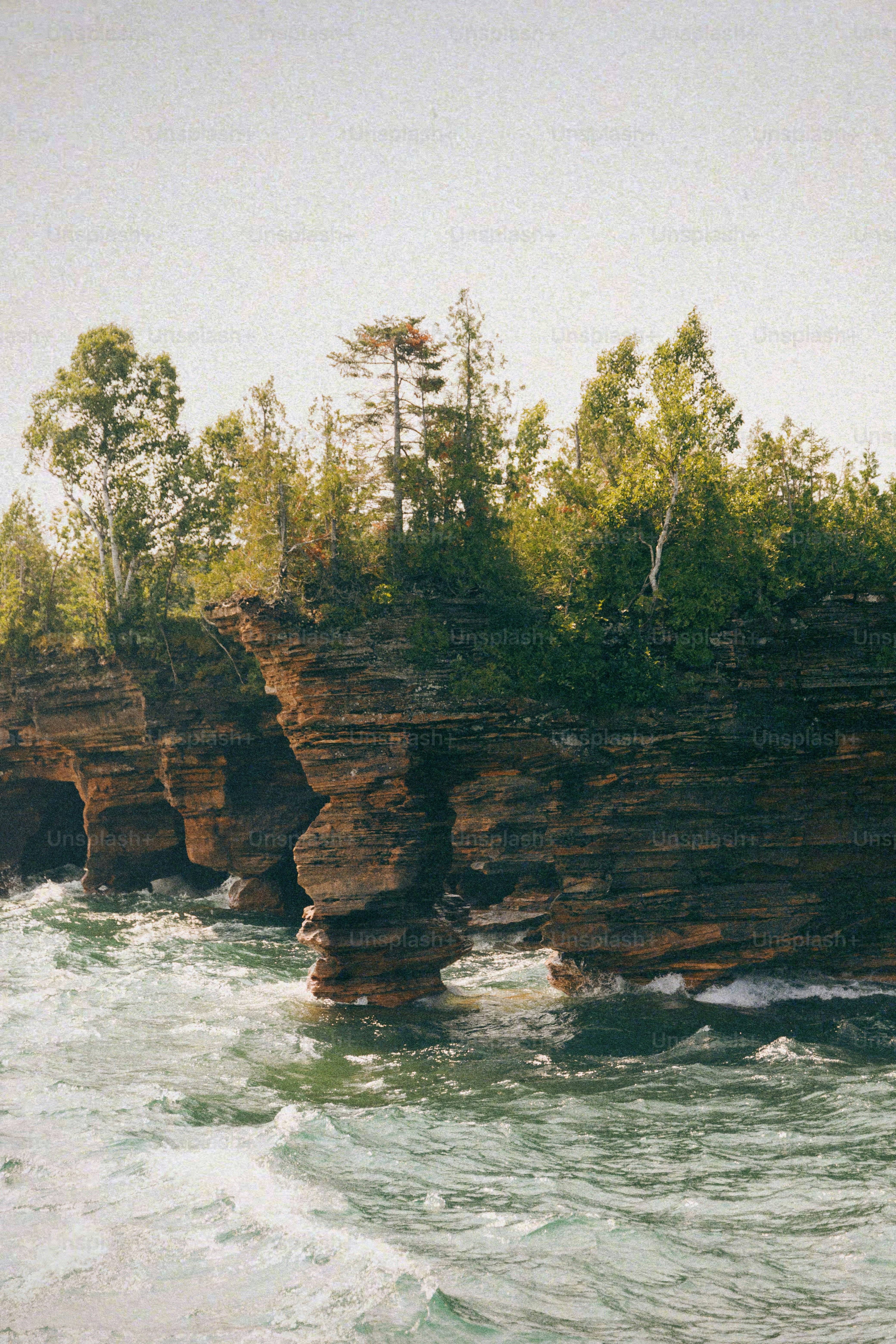 A group of rocks sitting on top of a body of water
