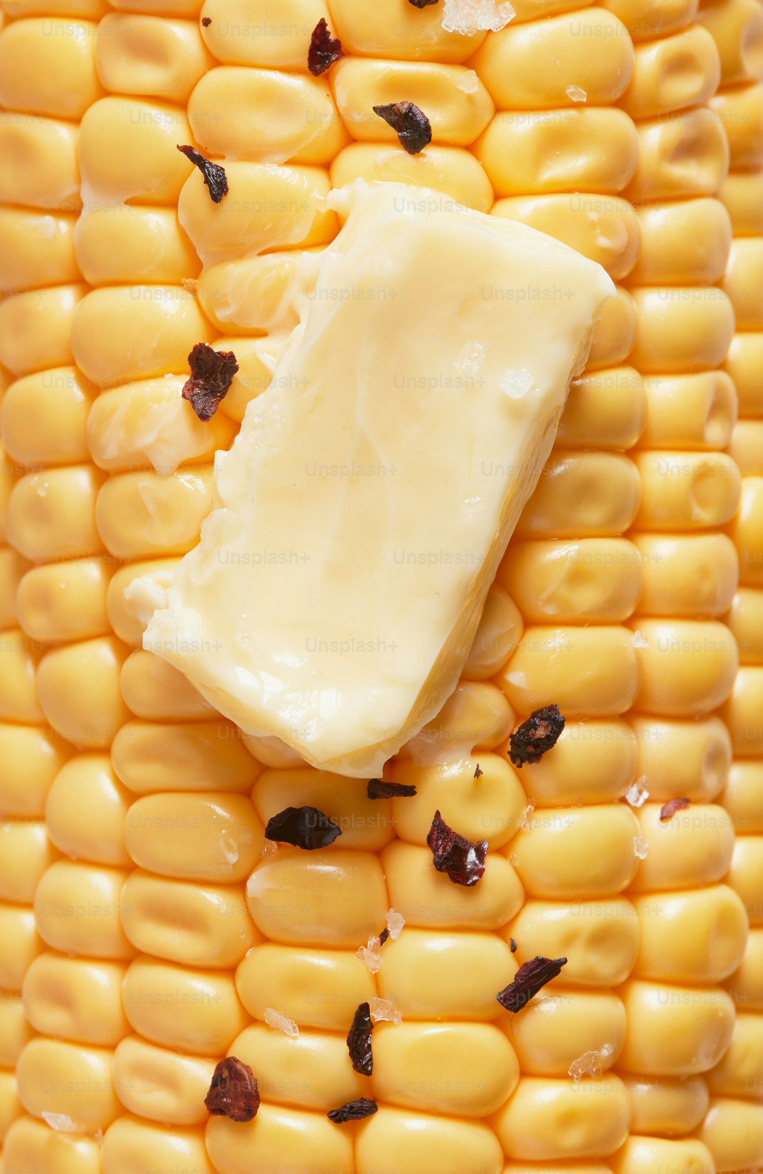 A piece of butter on top of a corn cob