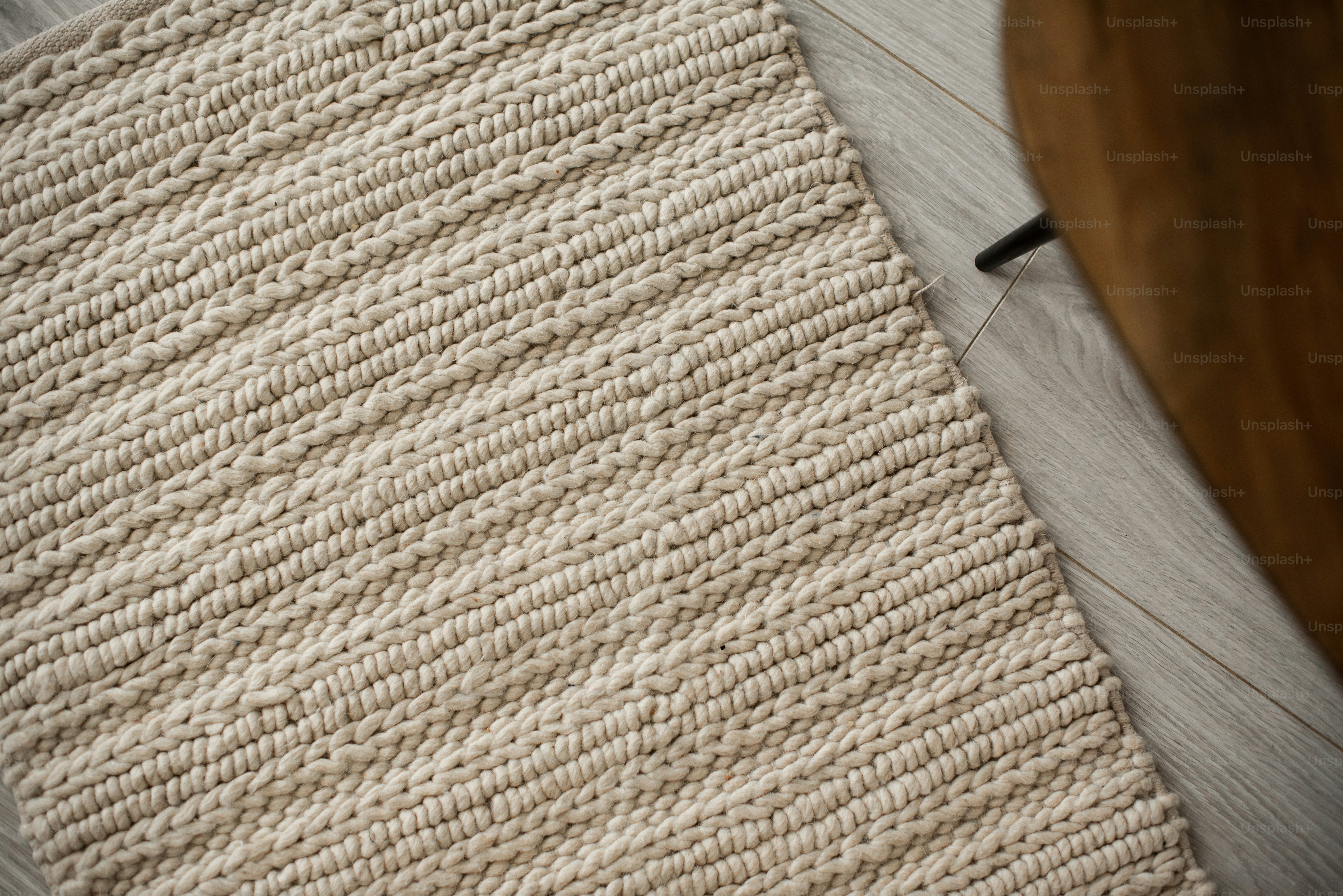 A close up of a rug on a wooden floor