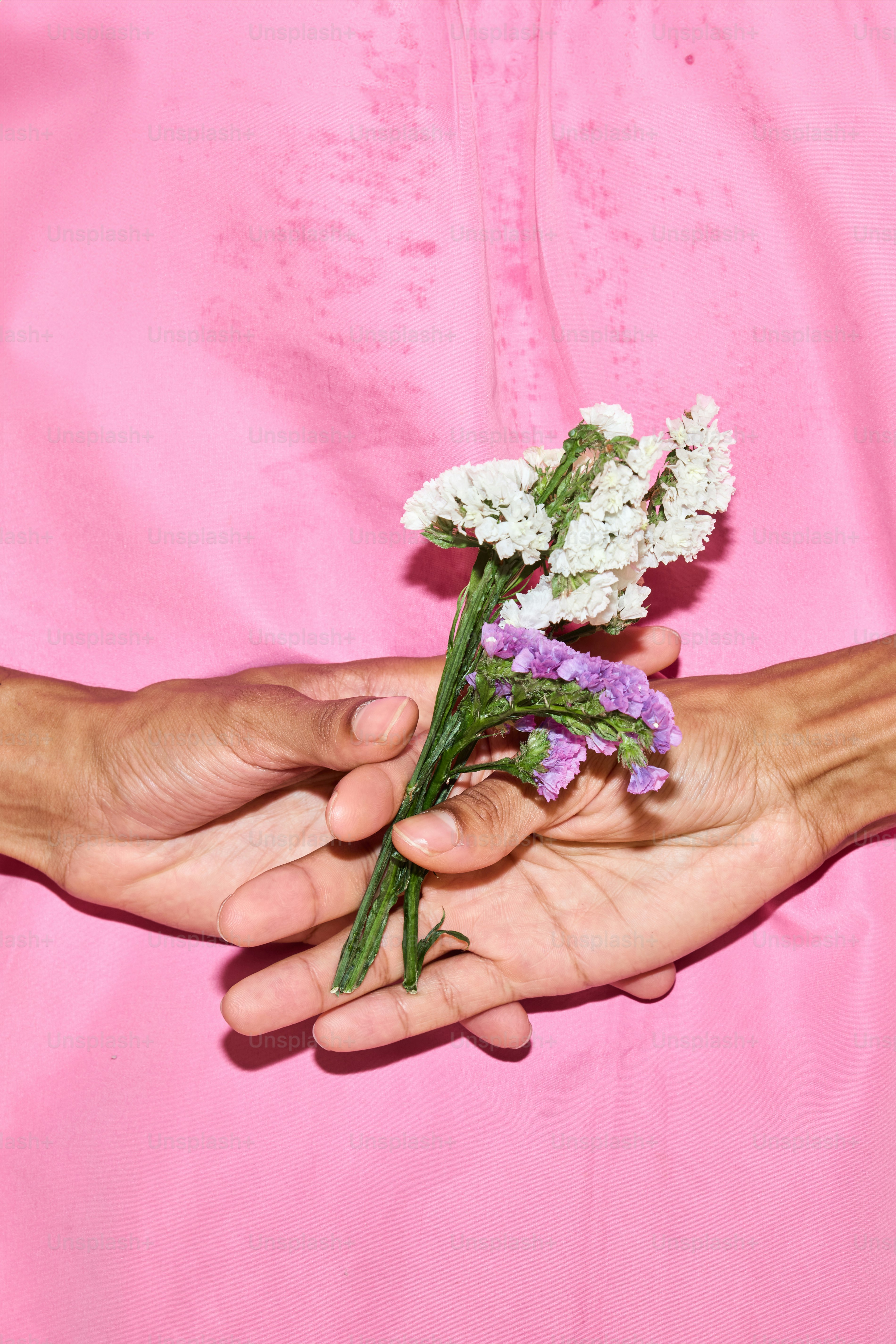 A person holding a bunch of flowers in their hands