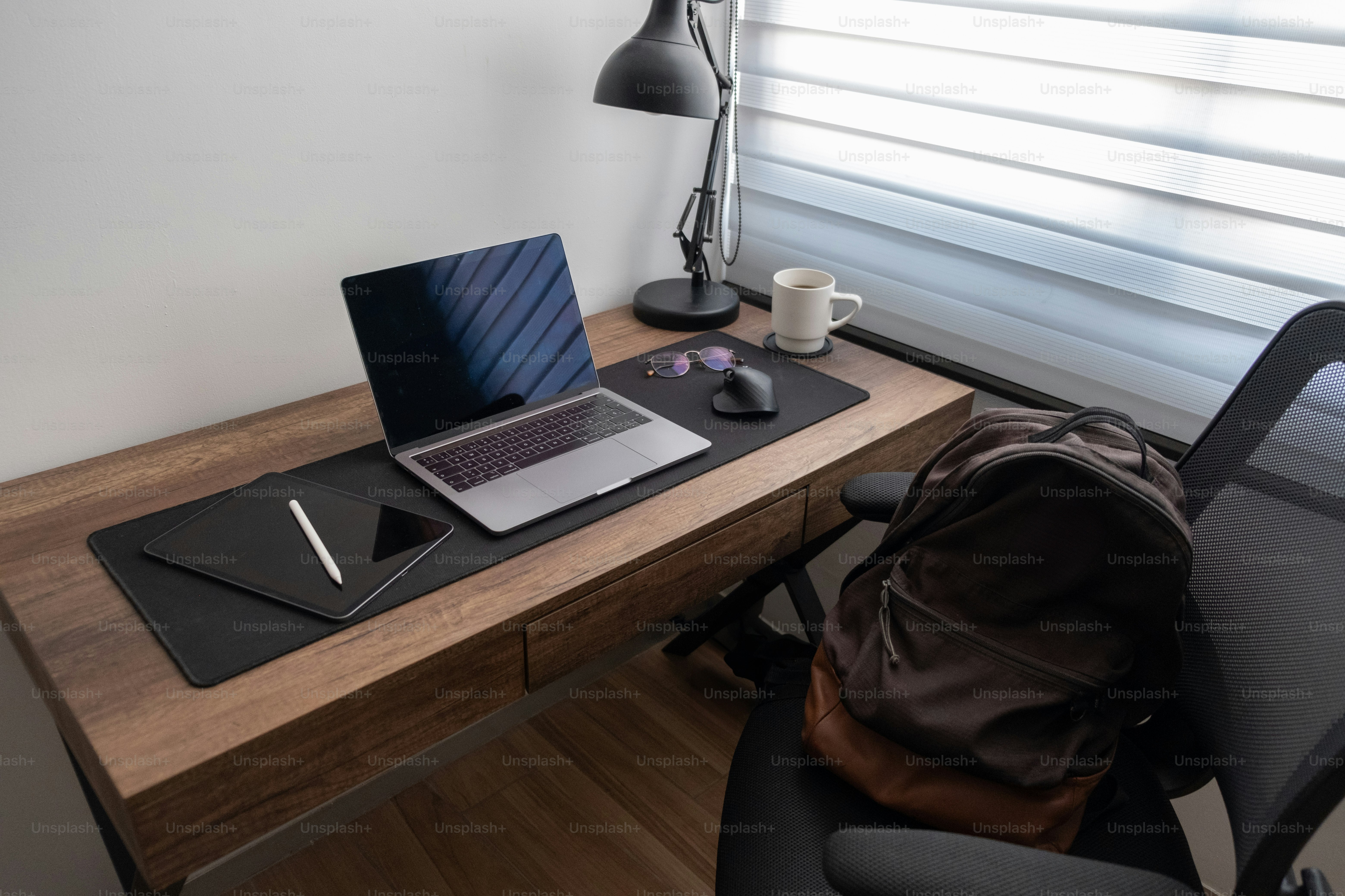 A laptop computer sitting on top of a wooden desk