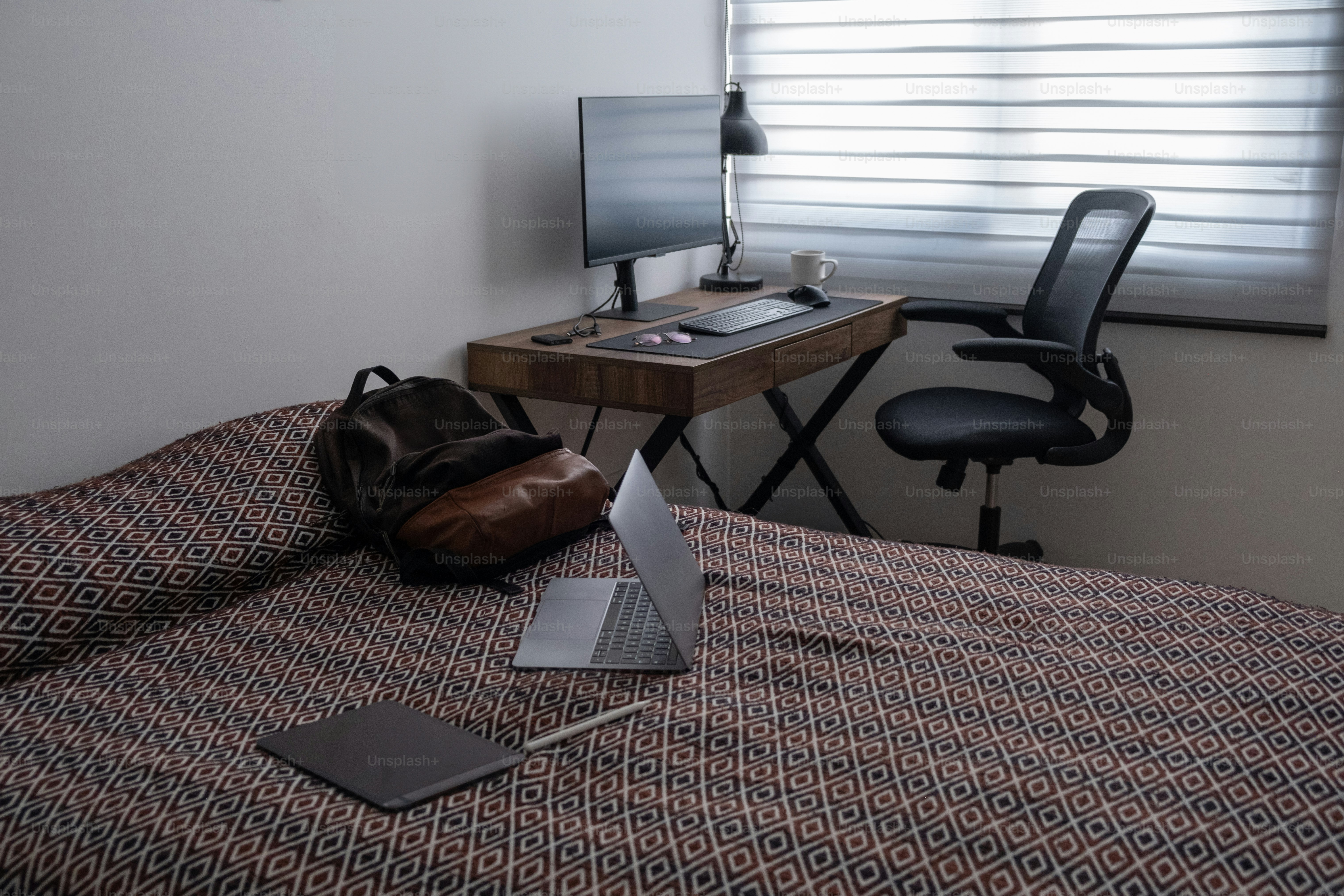 A laptop computer sitting on top of a bed