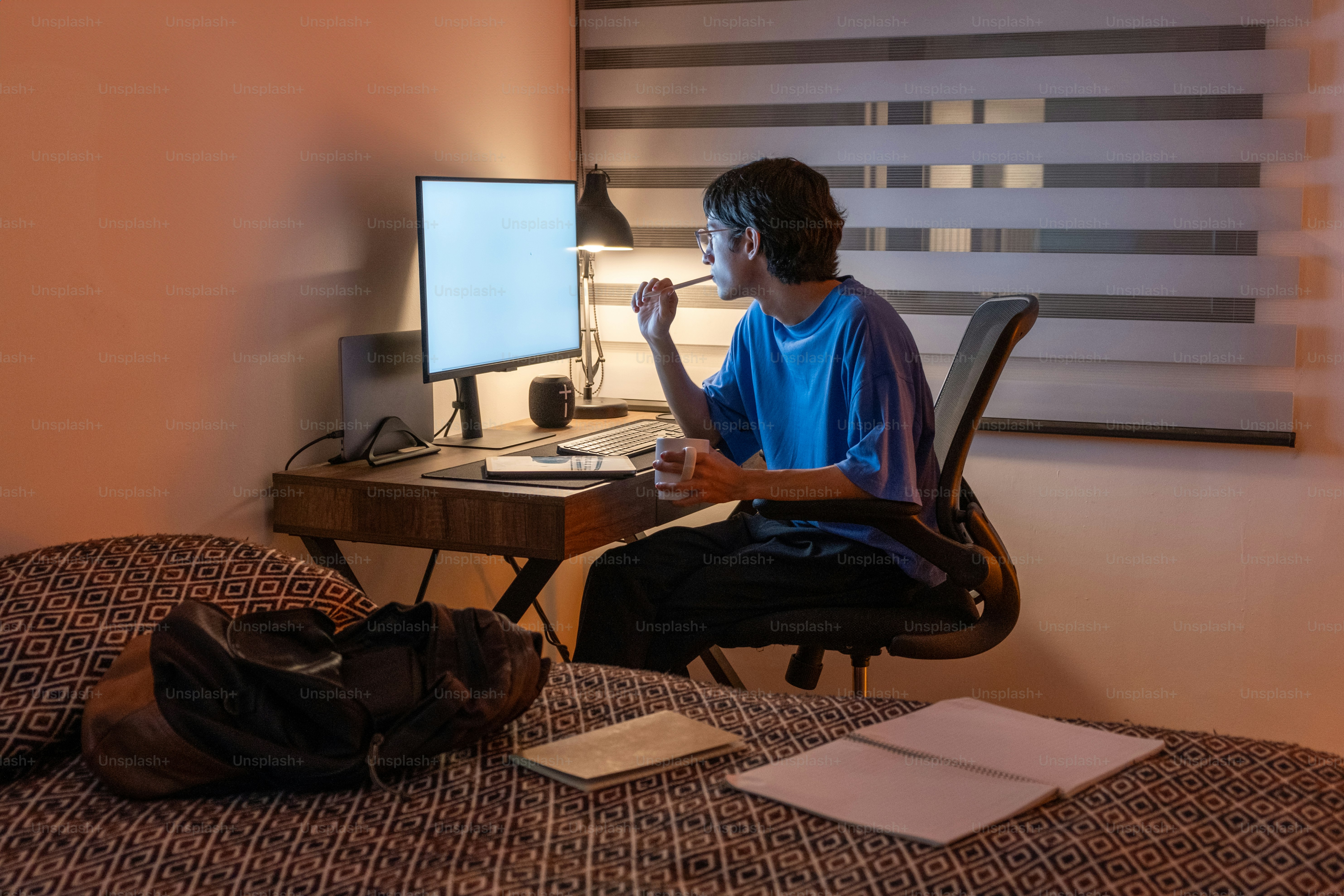 A man sitting at a desk in front of a computer