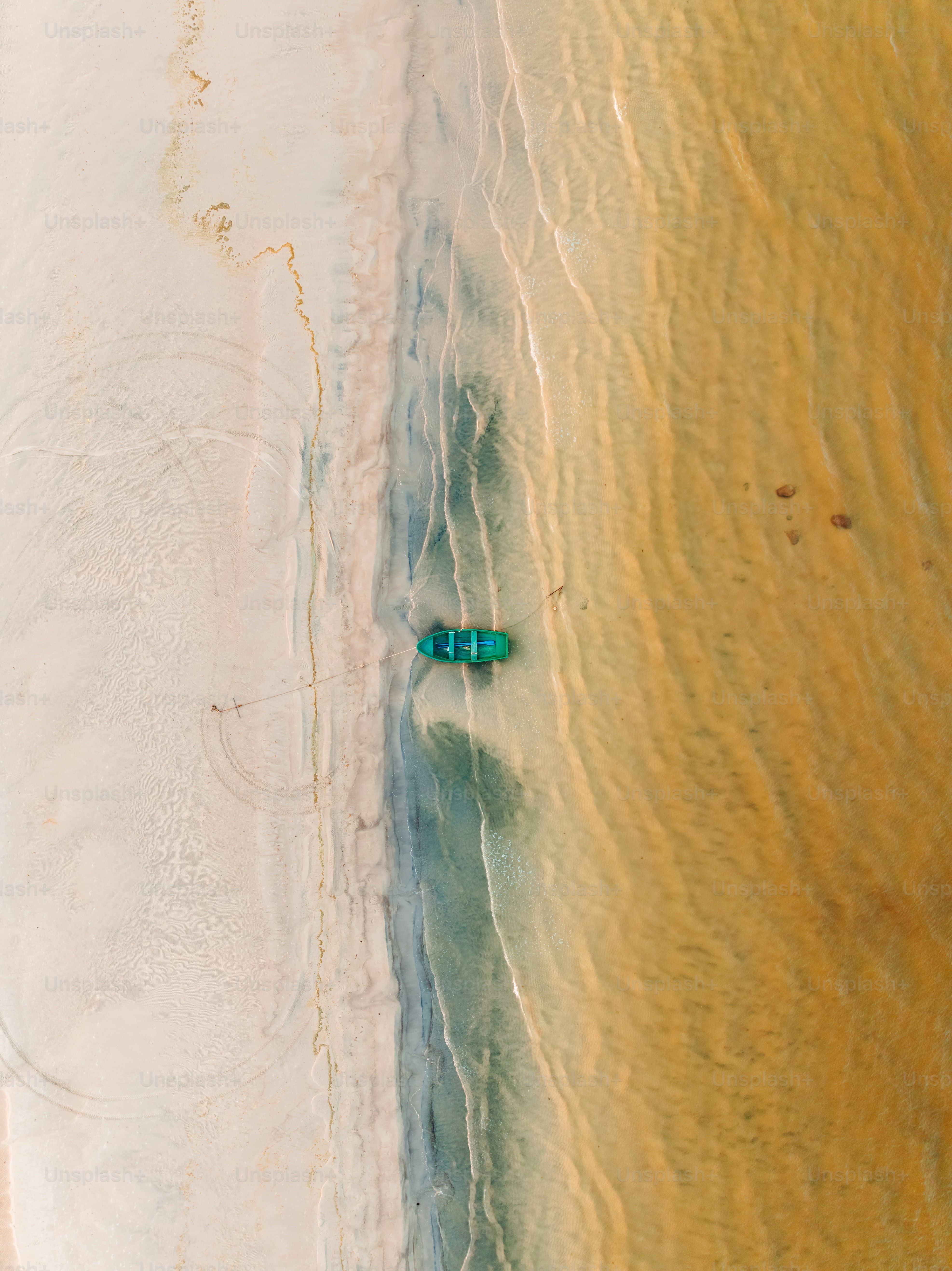 An aerial view of a beach with two people in the water