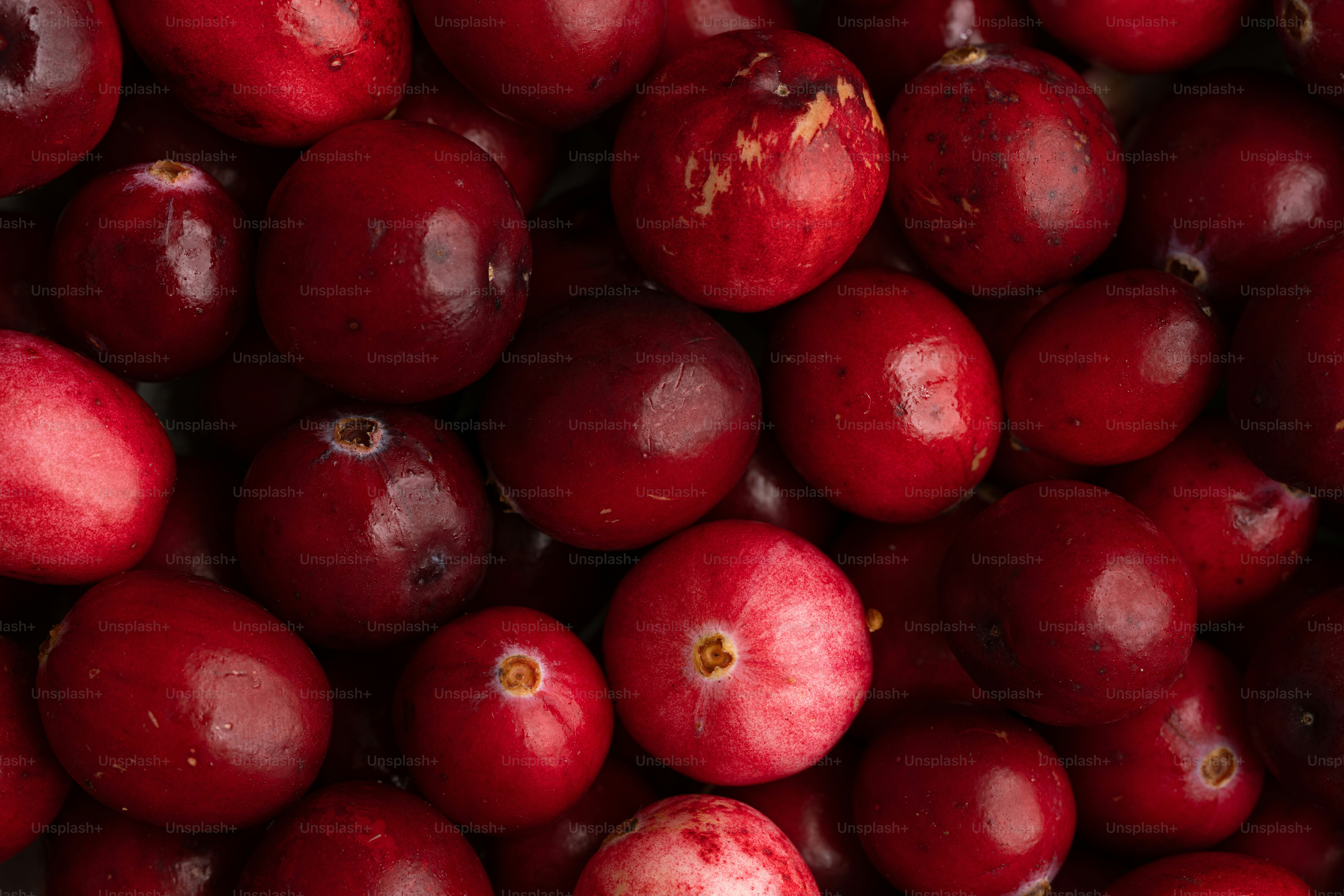 A pile of cranberries sitting next to each other