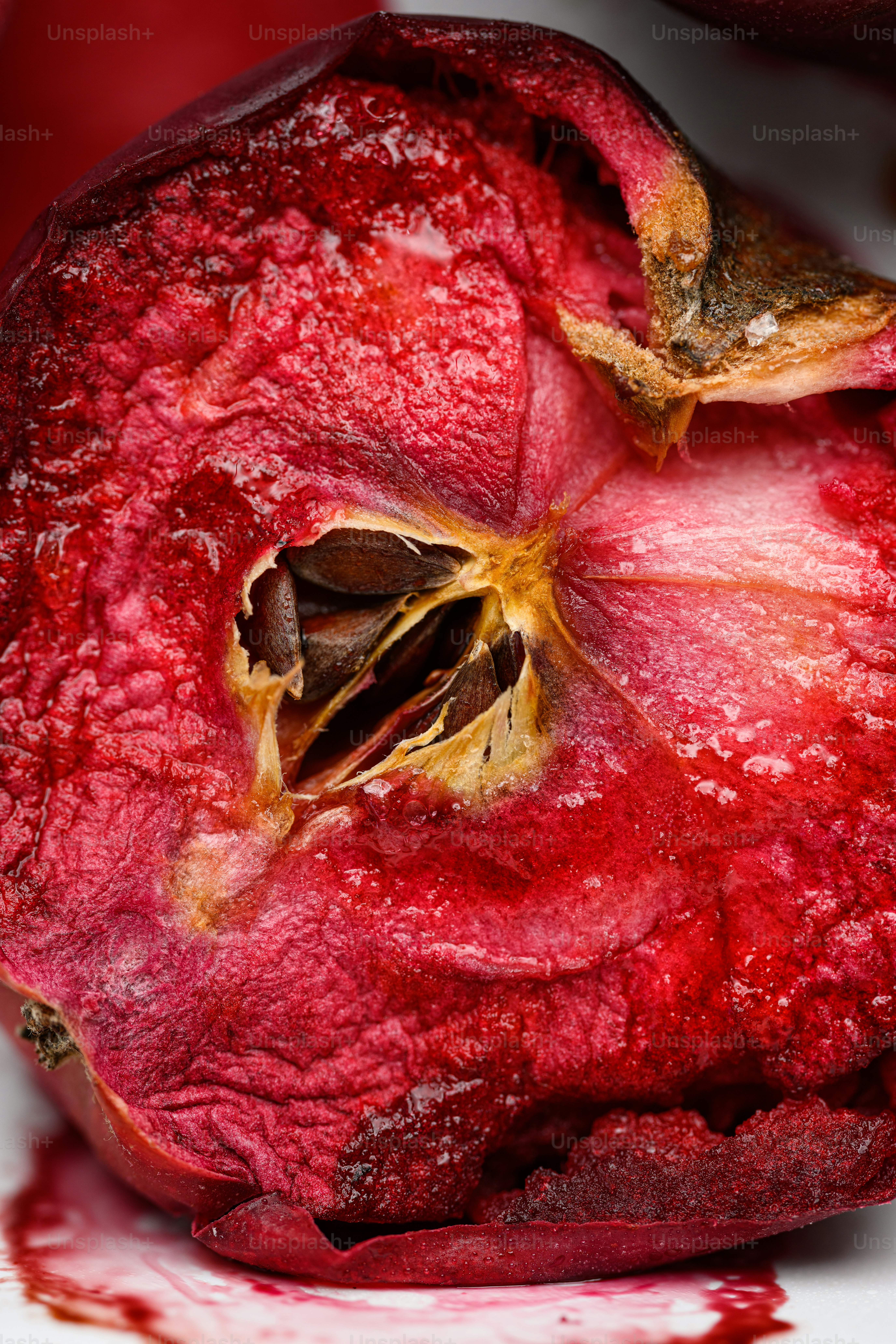 A rotten apple sitting on top of a white plate