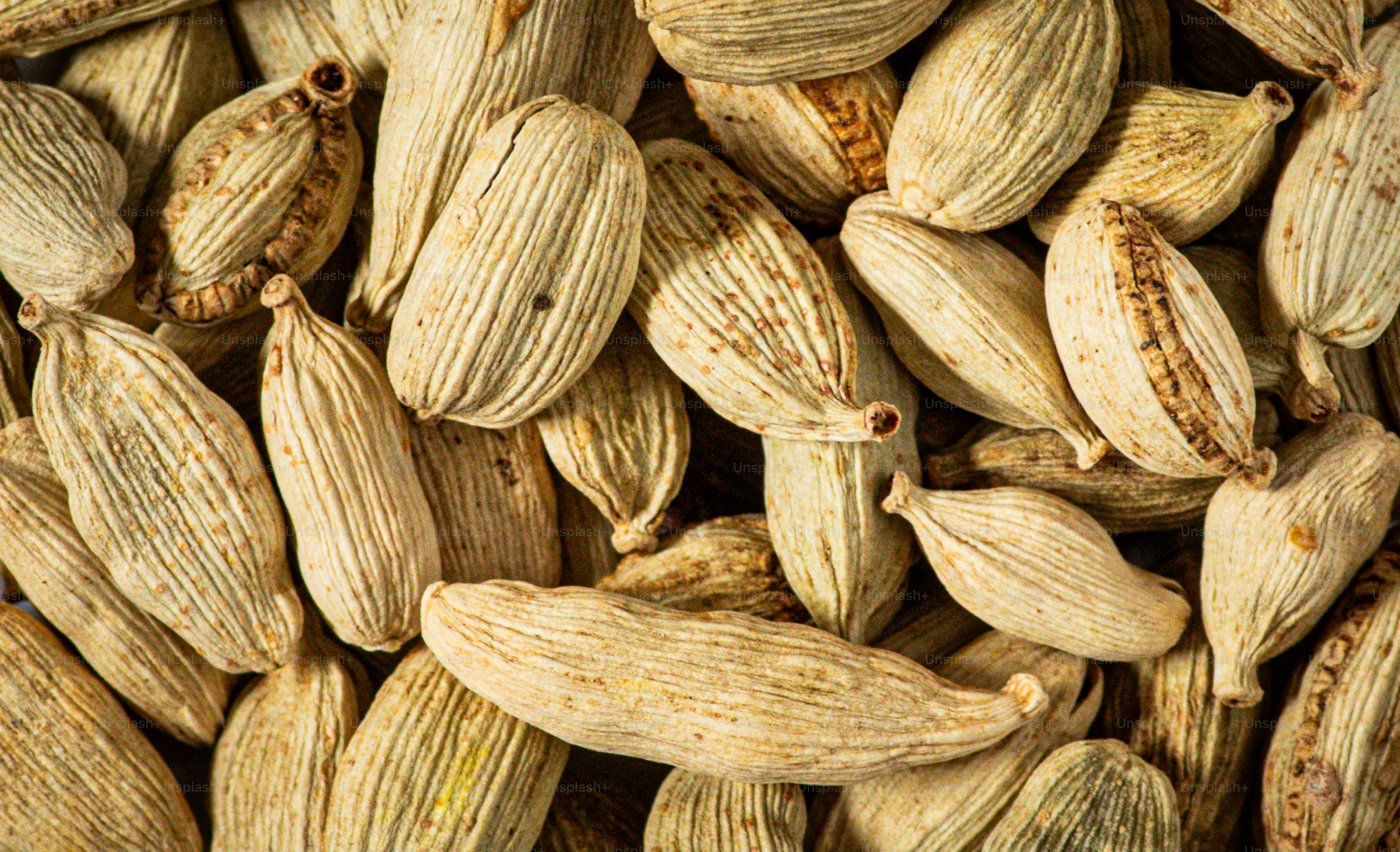 A pile of pistachioa seeds sitting on top of each other