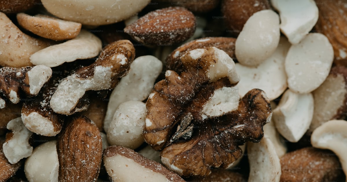 A close up of nuts and nutshells on a table photo – Mixed roasted nuts ...
