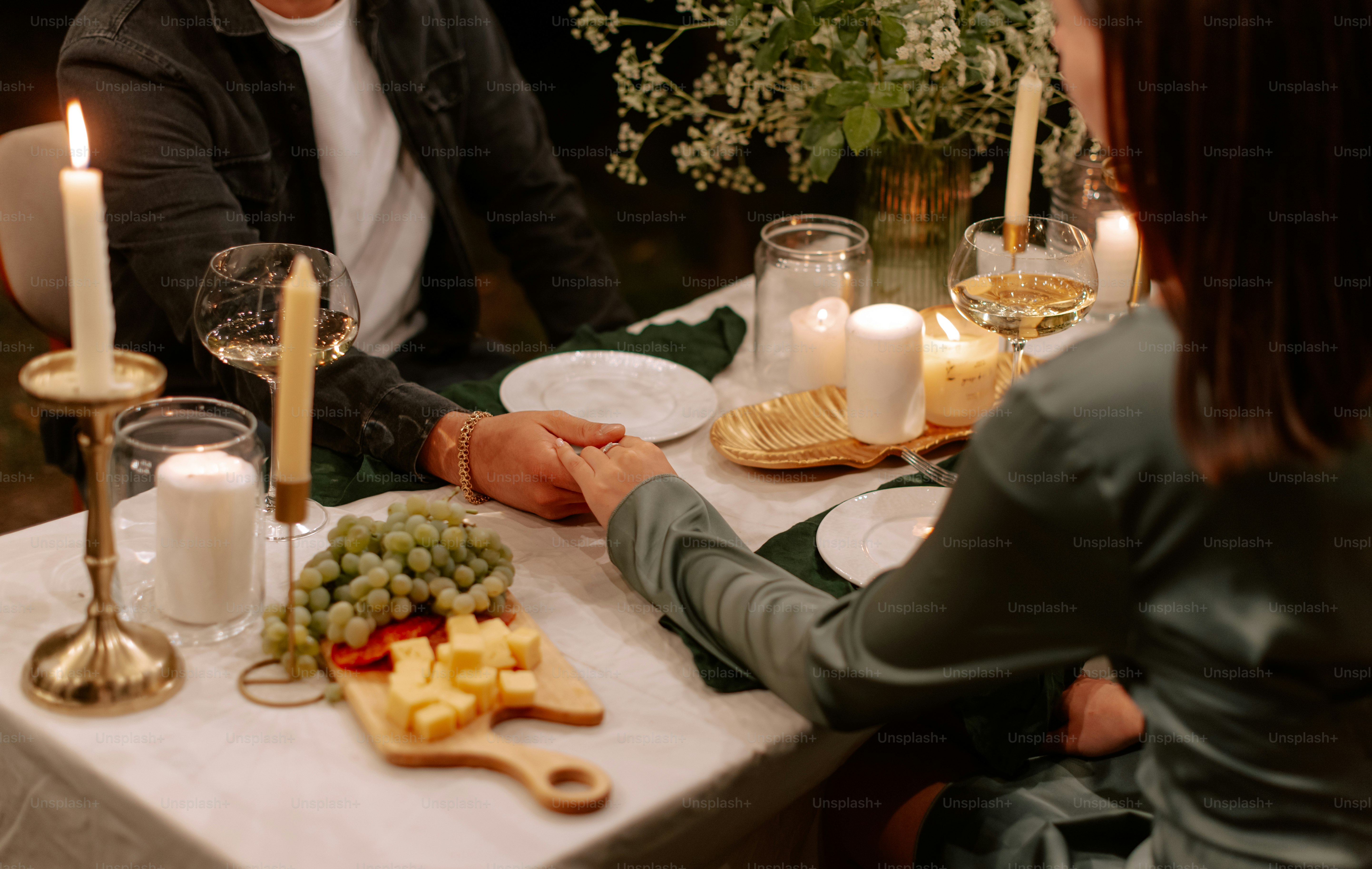 A man and woman sitting at a dinner table
