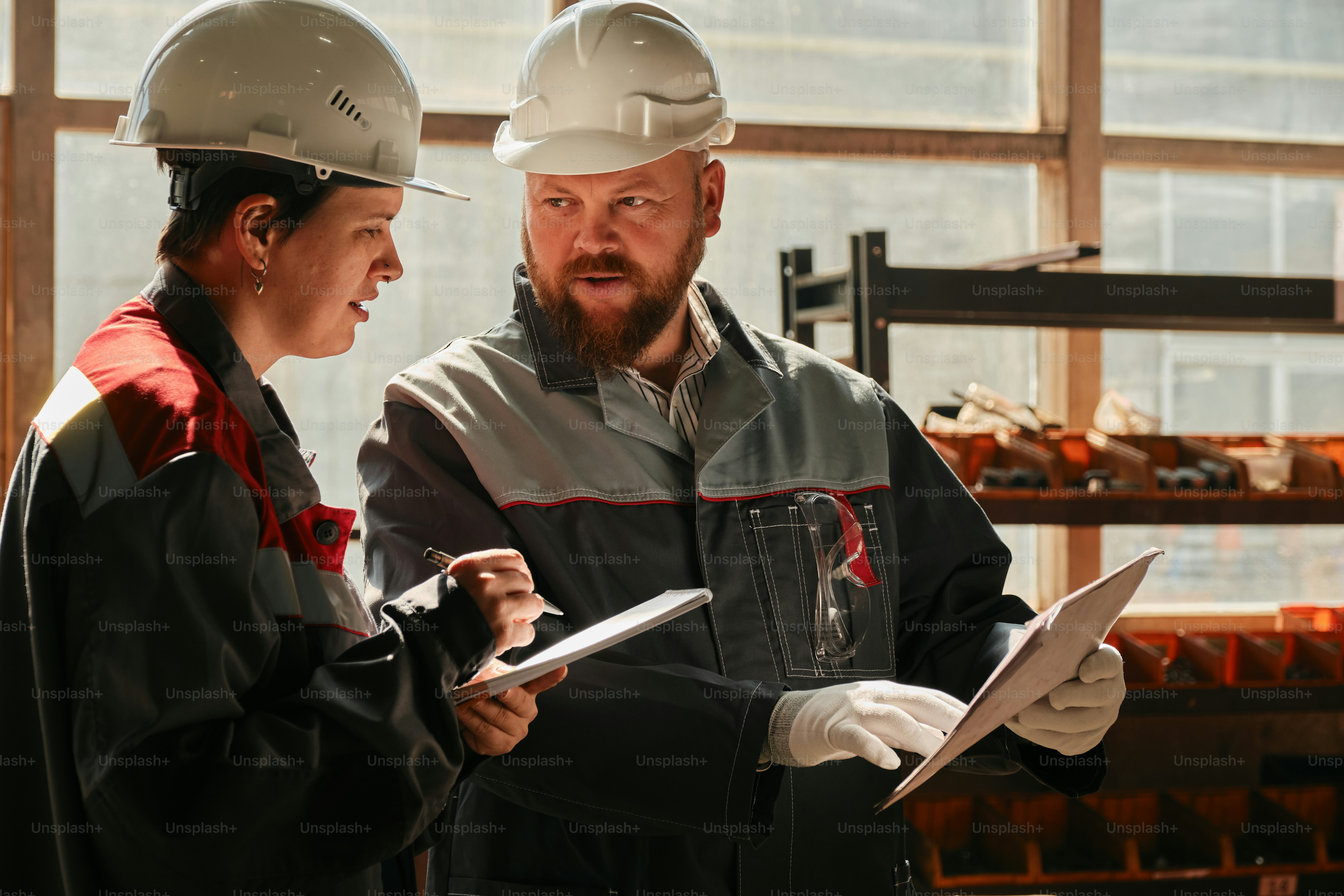 A man and a woman wearing hard hats